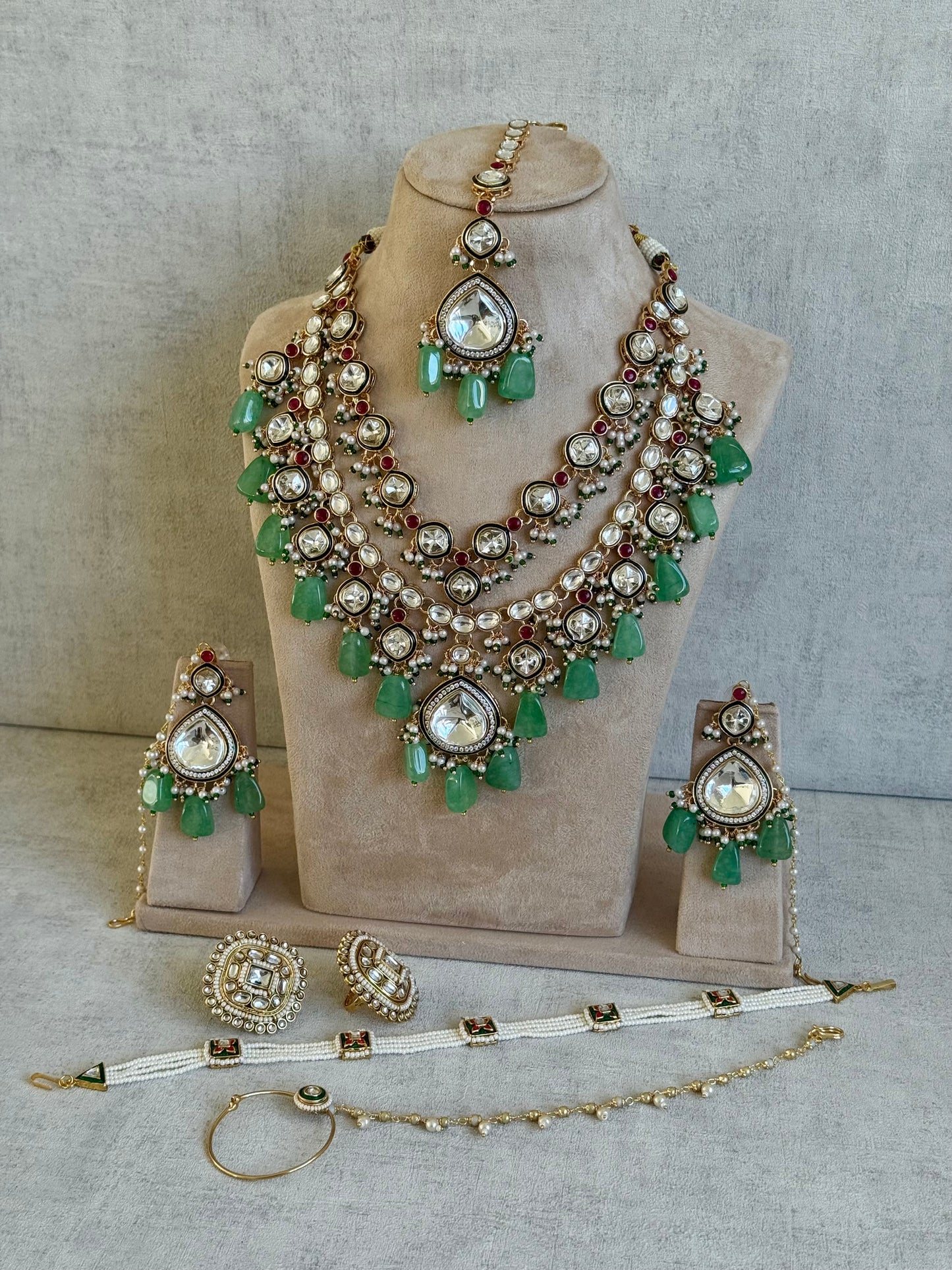 Ayura Designs Malika Bridal Set with Necklace, Jhumkis, Tikka, Nath, Ring & Sheeshphool – Jadau Kundan Craftsmanship with Mirror-Cut Polki, Jade-Toned Drops, Ruby Accents & Antique Gold Finish