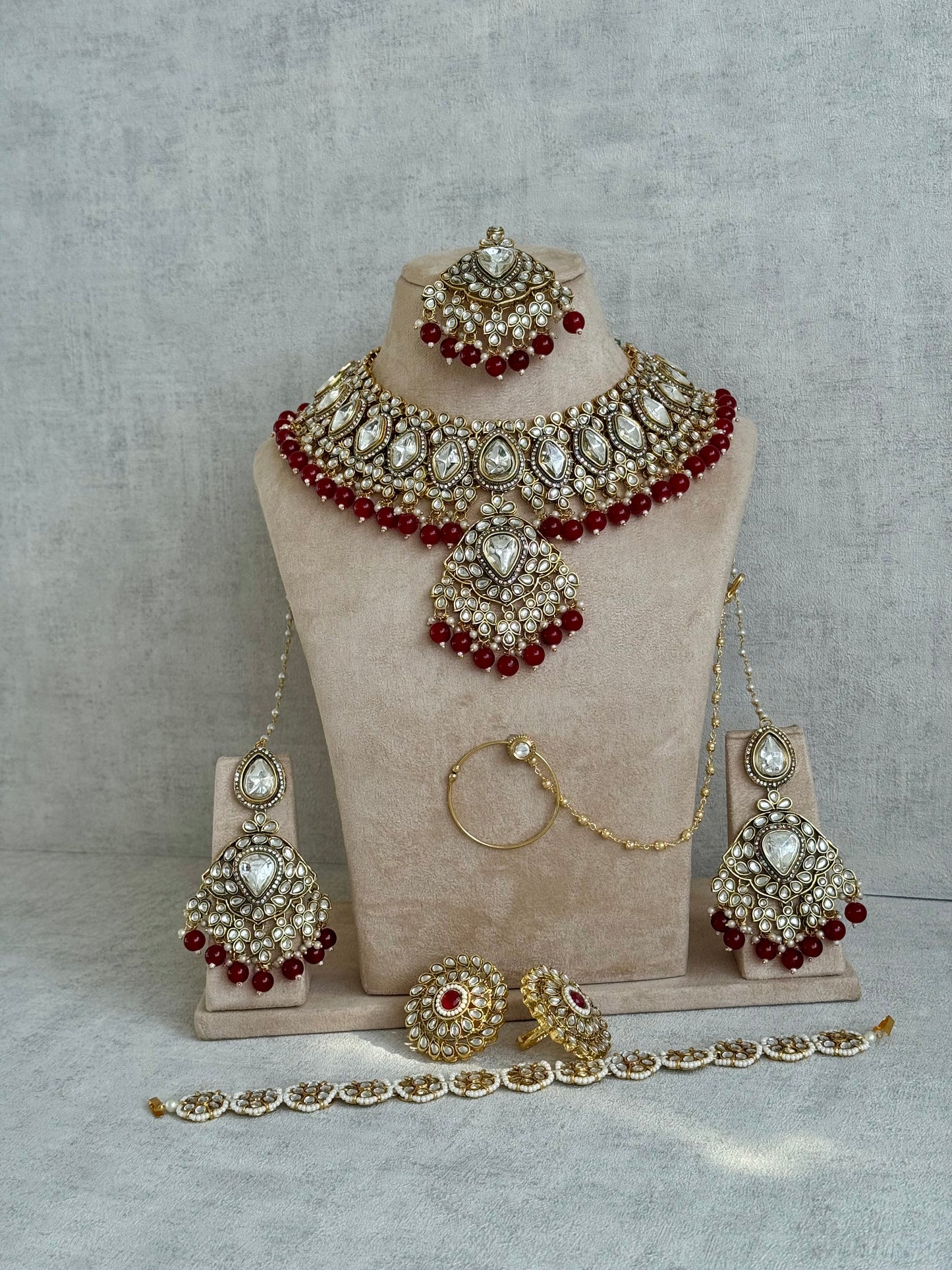 Ayura Designs Gulbahar Bridal Set with Necklace, Jhumkis, Tikka, Nath, Ring & Sheeshphool – Jadau Kundan Craftsmanship with Mirror-Cut Polki, Red Beads & Antique Gold Finish