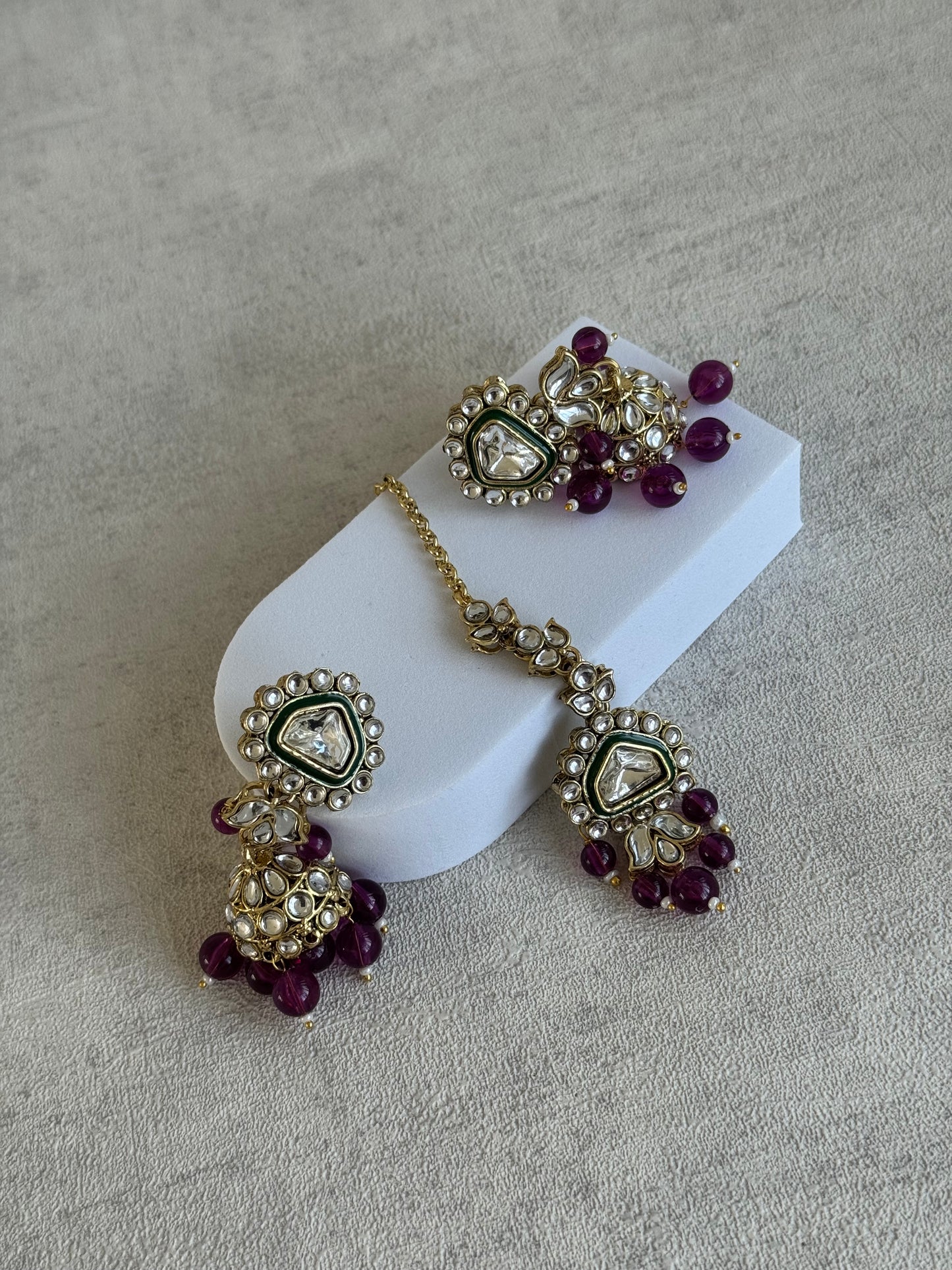 Ayura Designs Izza Set with Jhumkis & Tikka – Mirror-Cut Kundan Stones, Deep Plum Beads & Emerald Green Enamel Finish