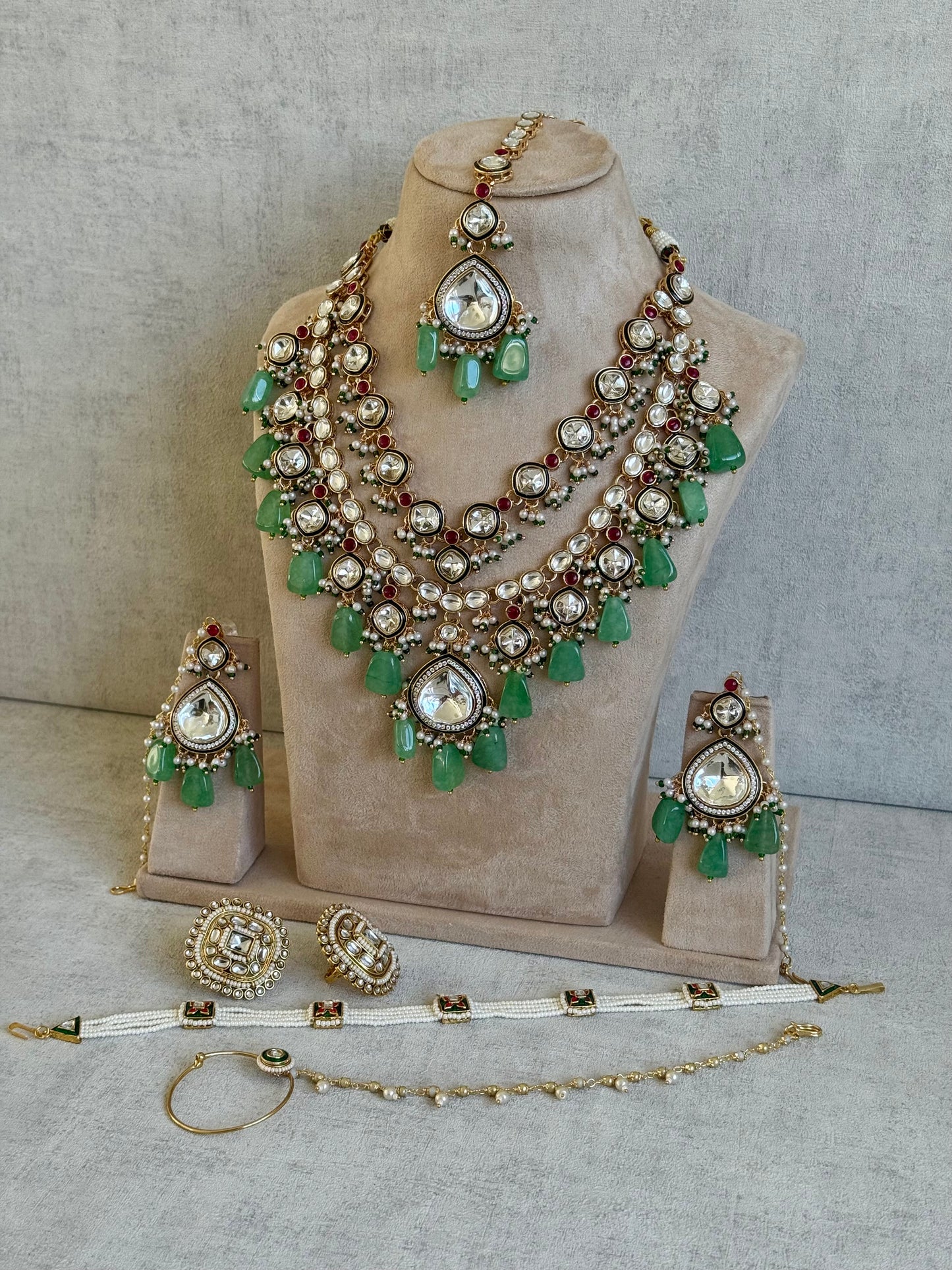 Ayura Designs Malika Bridal Set with Necklace, Jhumkis, Tikka, Nath, Ring & Sheeshphool – Jadau Kundan Craftsmanship with Mirror-Cut Polki, Jade-Toned Drops, Ruby Accents & Antique Gold Finish