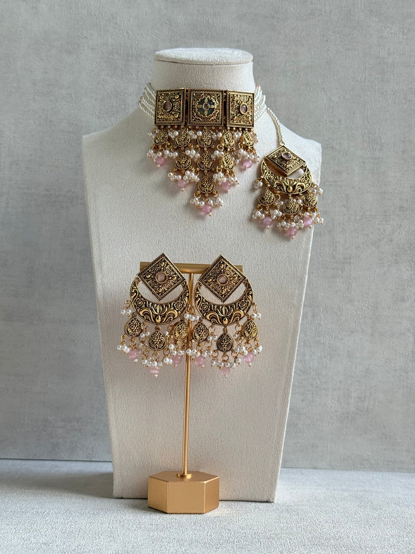 Ayura Designs Samera Choker Set with Earrings & Tikka – Blush Pink Beads, Pearl Detailing, Green Centre Stone, Floral Motifs & Antique Gold Finish