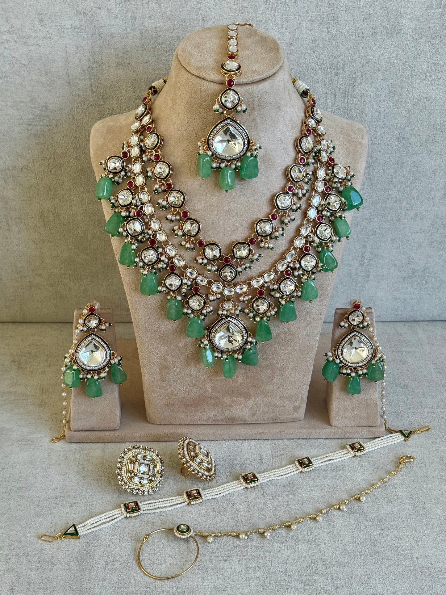 Ayura Designs Malika Bridal Set with Necklace, Jhumkis, Tikka, Nath, Ring & Sheeshphool – Jadau Kundan Craftsmanship with Mirror-Cut Polki, Jade-Toned Drops, Ruby Accents & Antique Gold Finish