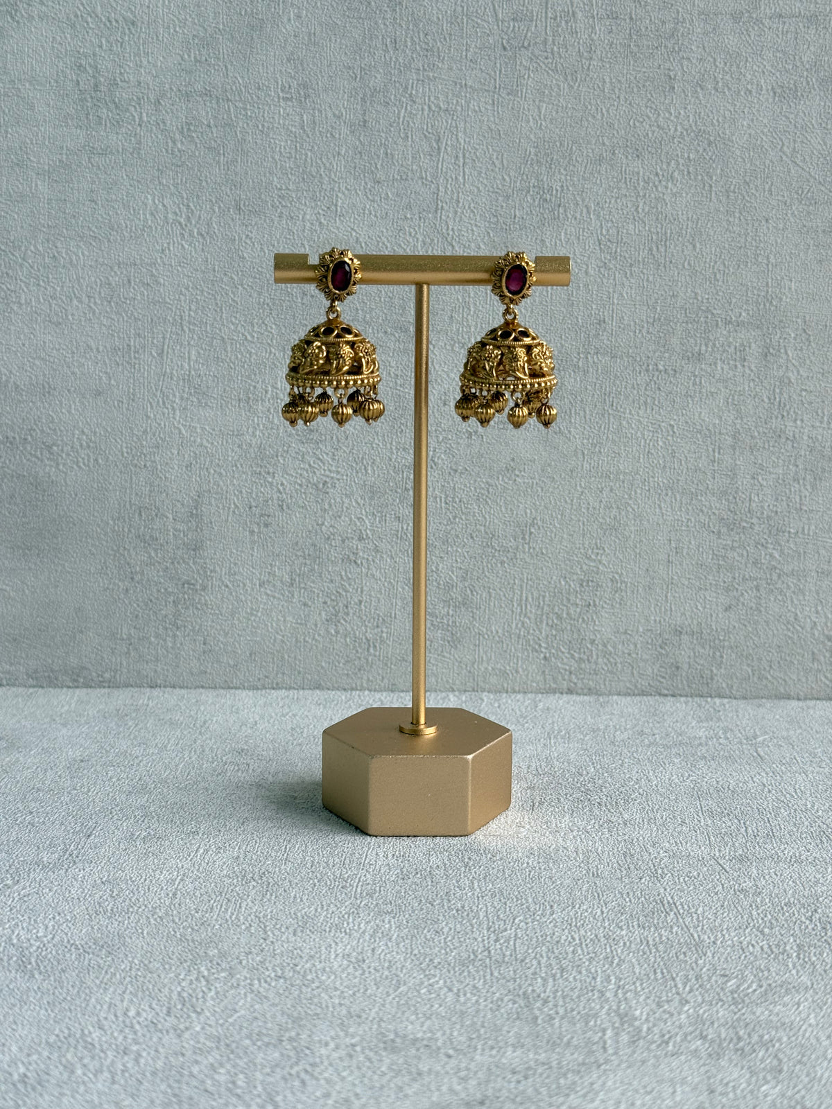Ayura Designs Savya Jhumkis – Rani Pink Stones, Floral Motifs & Antique Gold Finish