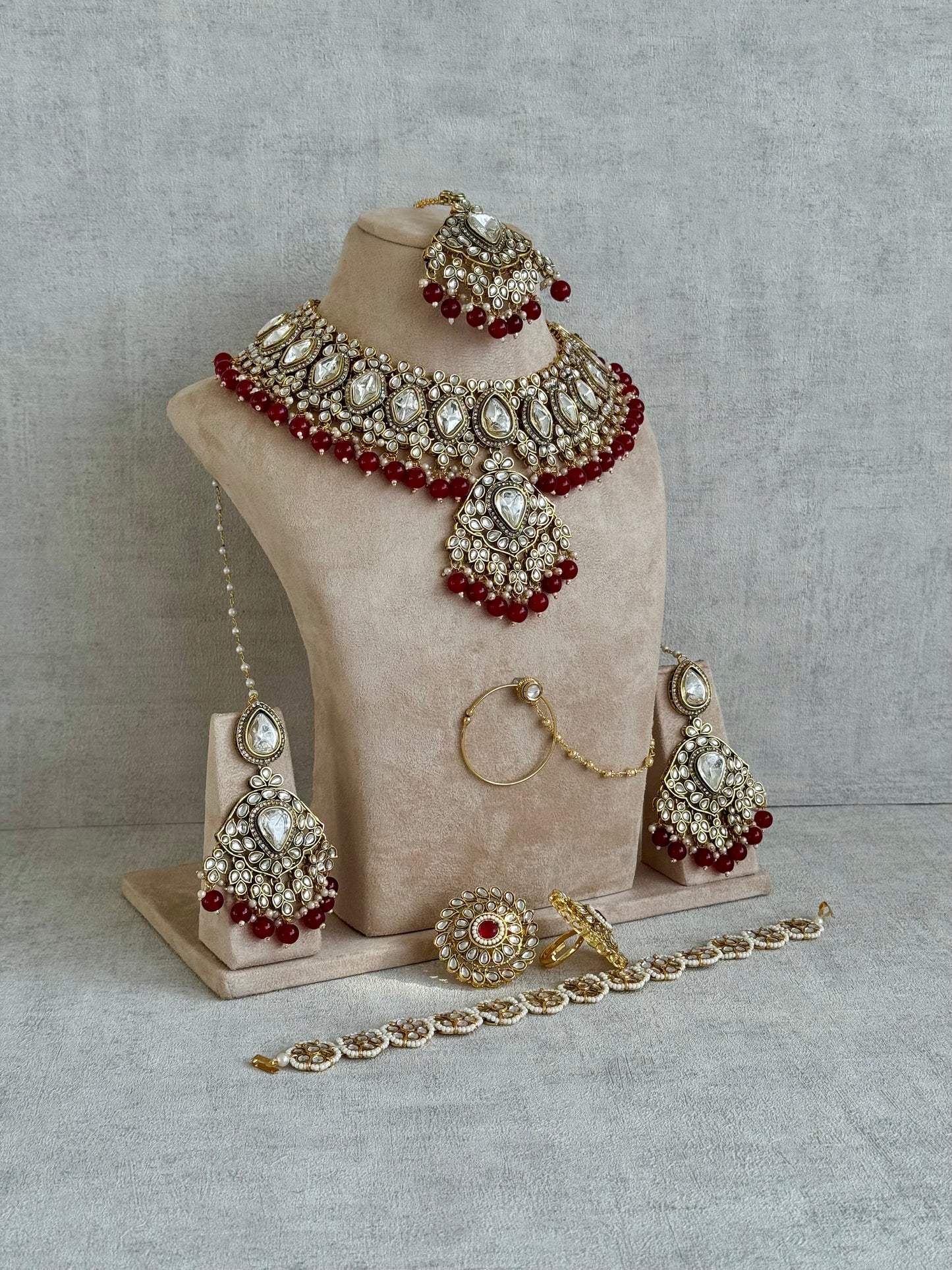 Ayura Designs Gulbahar Bridal Set with Necklace, Jhumkis, Tikka, Nath, Ring & Sheeshphool – Jadau Kundan Craftsmanship with Mirror-Cut Polki, Red Beads & Antique Gold Finish