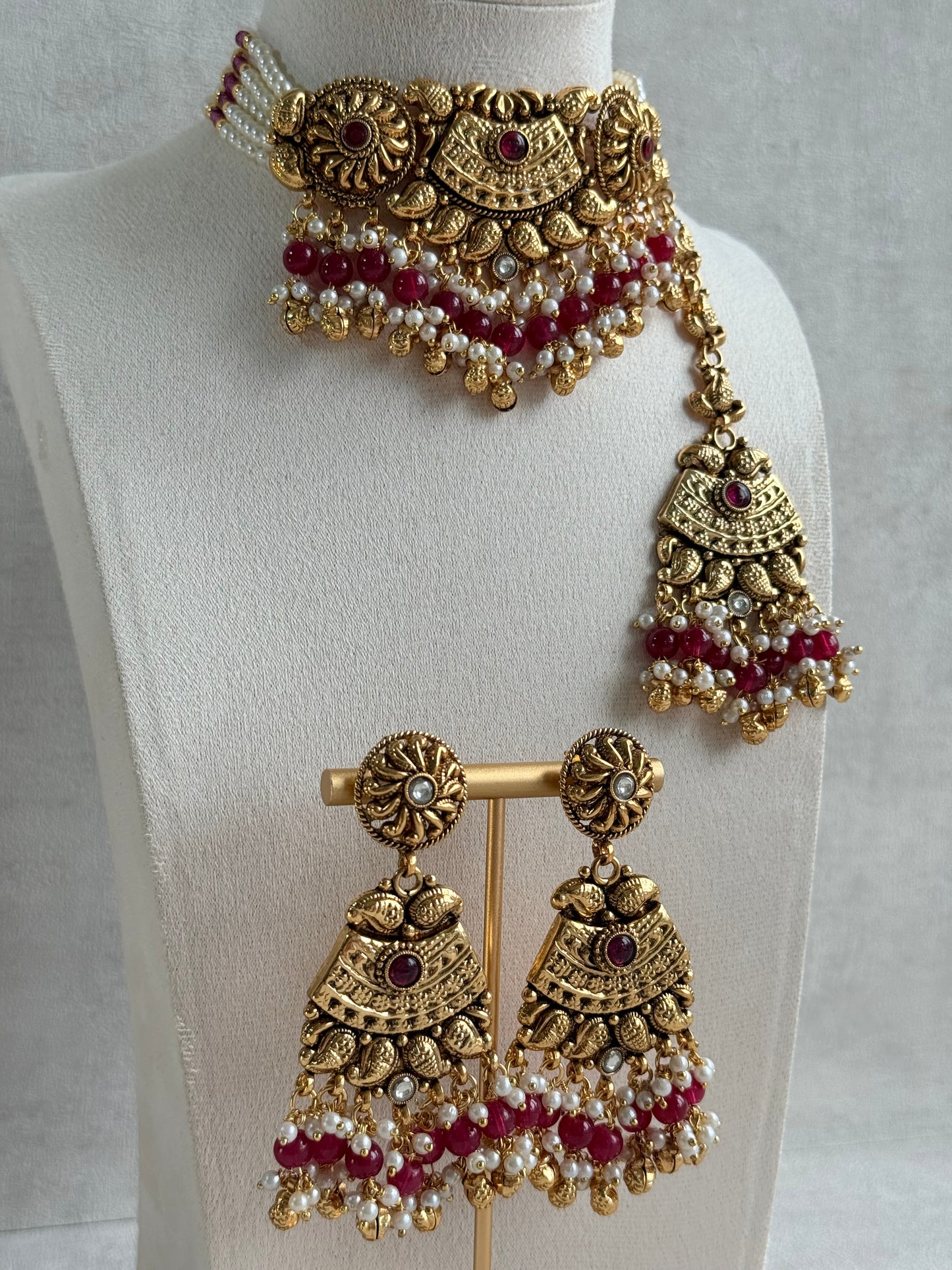 Ayura Designs Sairish Choker Set with Earrings & Tikka – Ruby Pink Beads, Pearl Detailing, Ghungroos, Paisley Motifs & Antique Gold Finish