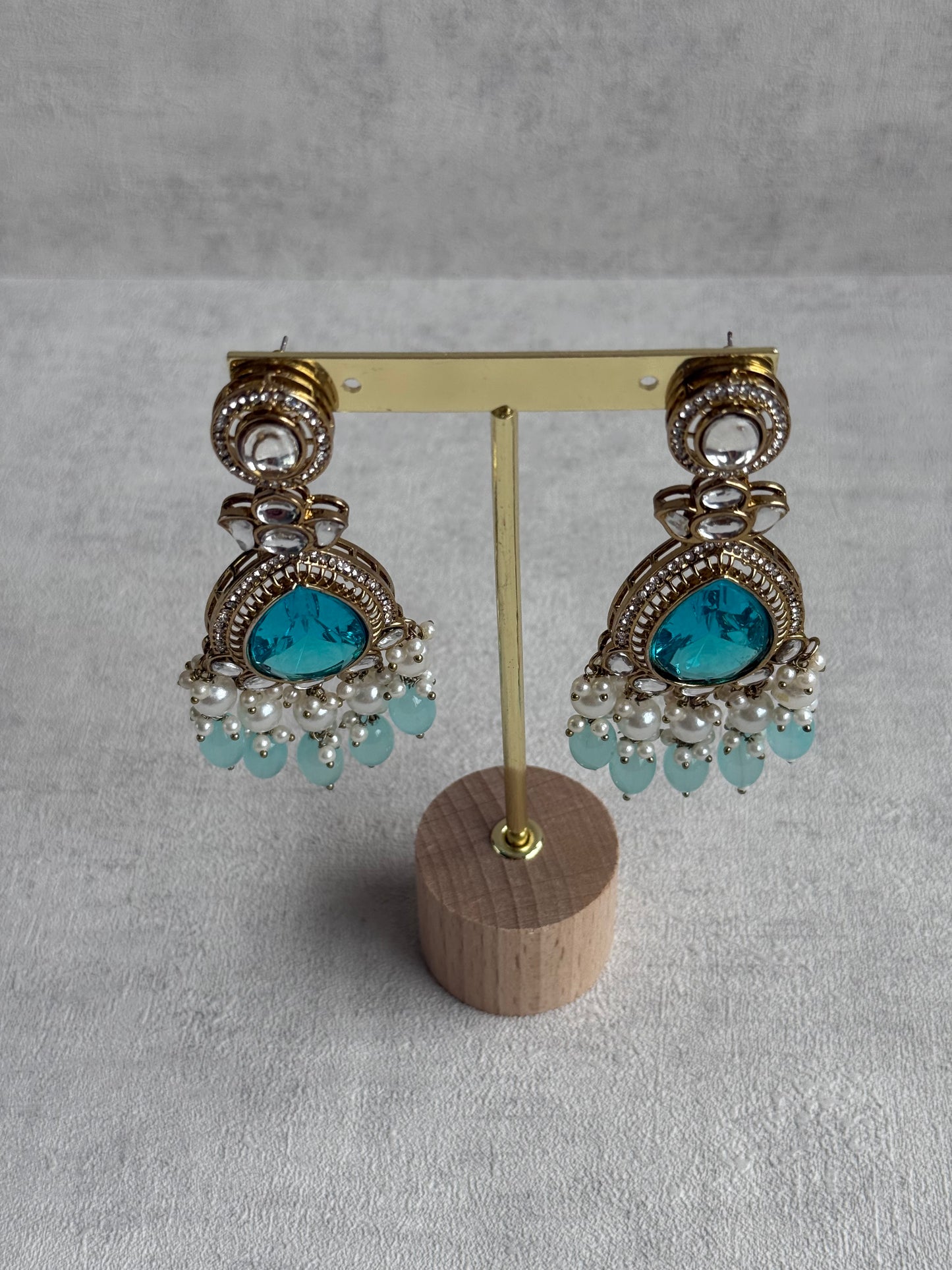 Ayura Designs Nageen Earrings – Antique Gold Jhumkis with Aqua Blue Stones, Mirror-Cut Accents & Pearl Drops