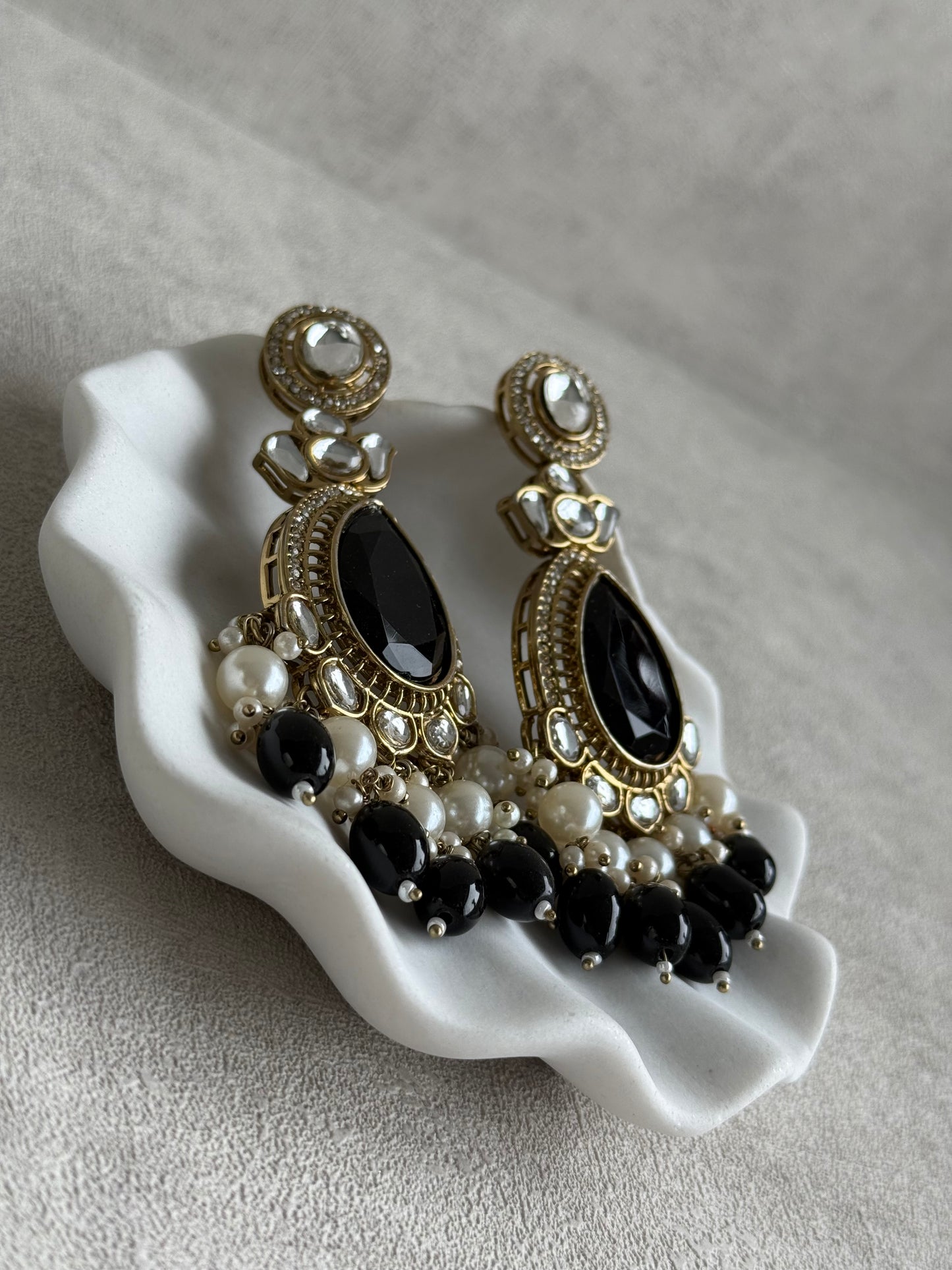 Ayura Designs Nageen Earrings – Antique Gold Jhumkis with Black Stones, Mirror-Cut Accents & Pearl Drops