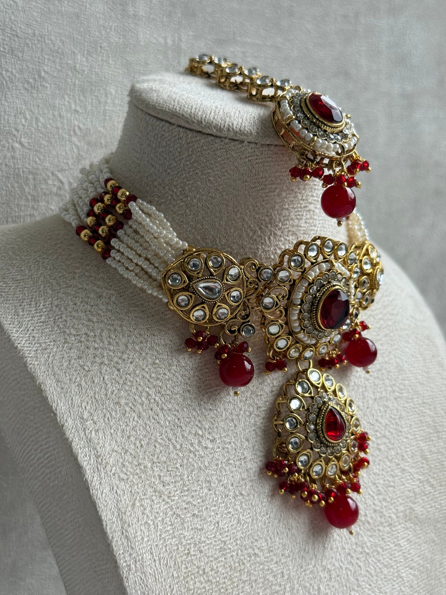 Ayura Designs Muskaan Set – Choker, Jhumkis & Tikka with Ruby Red Beads, Kundan Stones & Antique Gold Finish