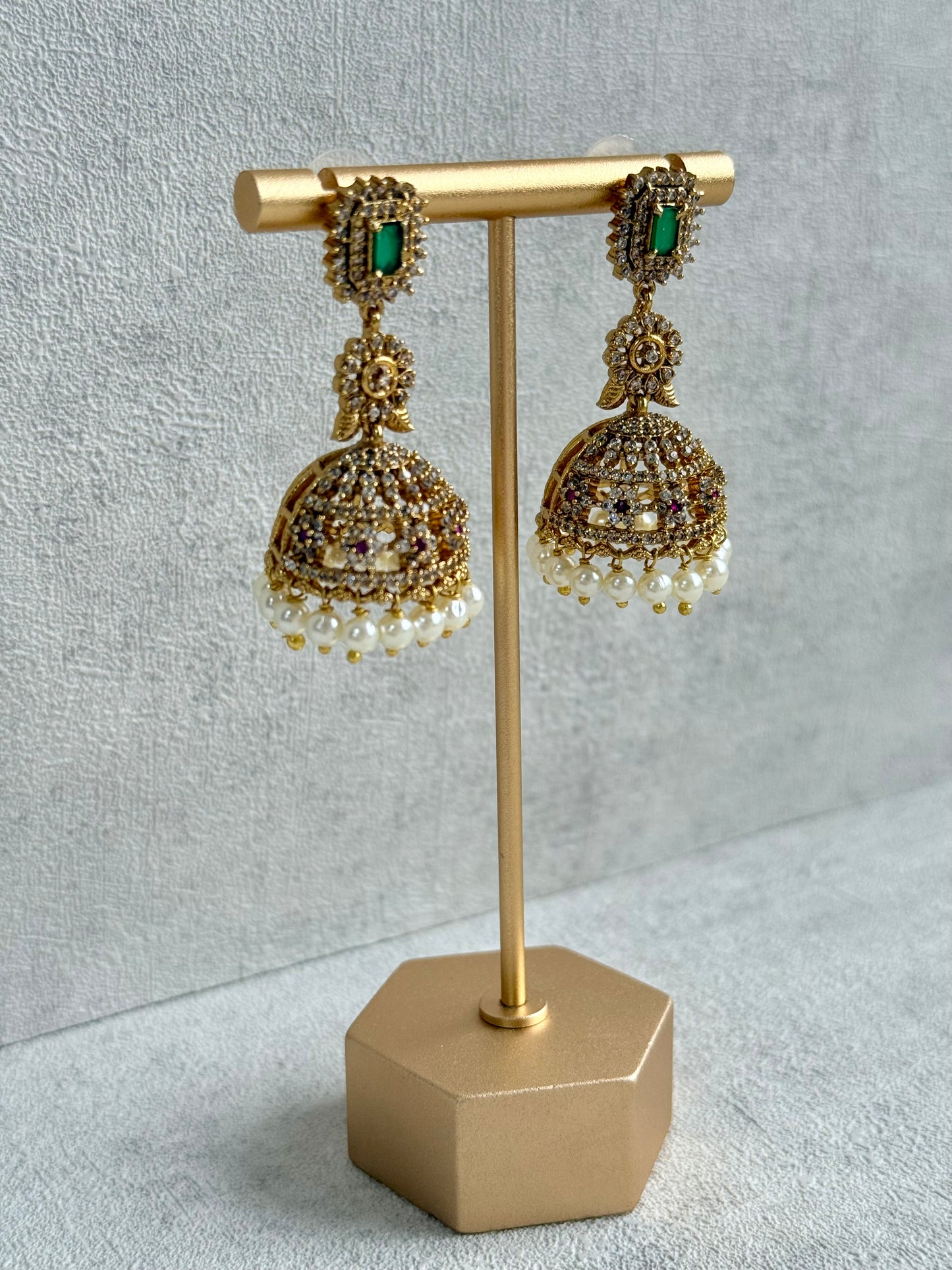 Ayura Designs Maya Jhumkis – Gold Jhumkis with Emerald Green Studs, Pink Stones, Crystal Detailing & Pearl Drops