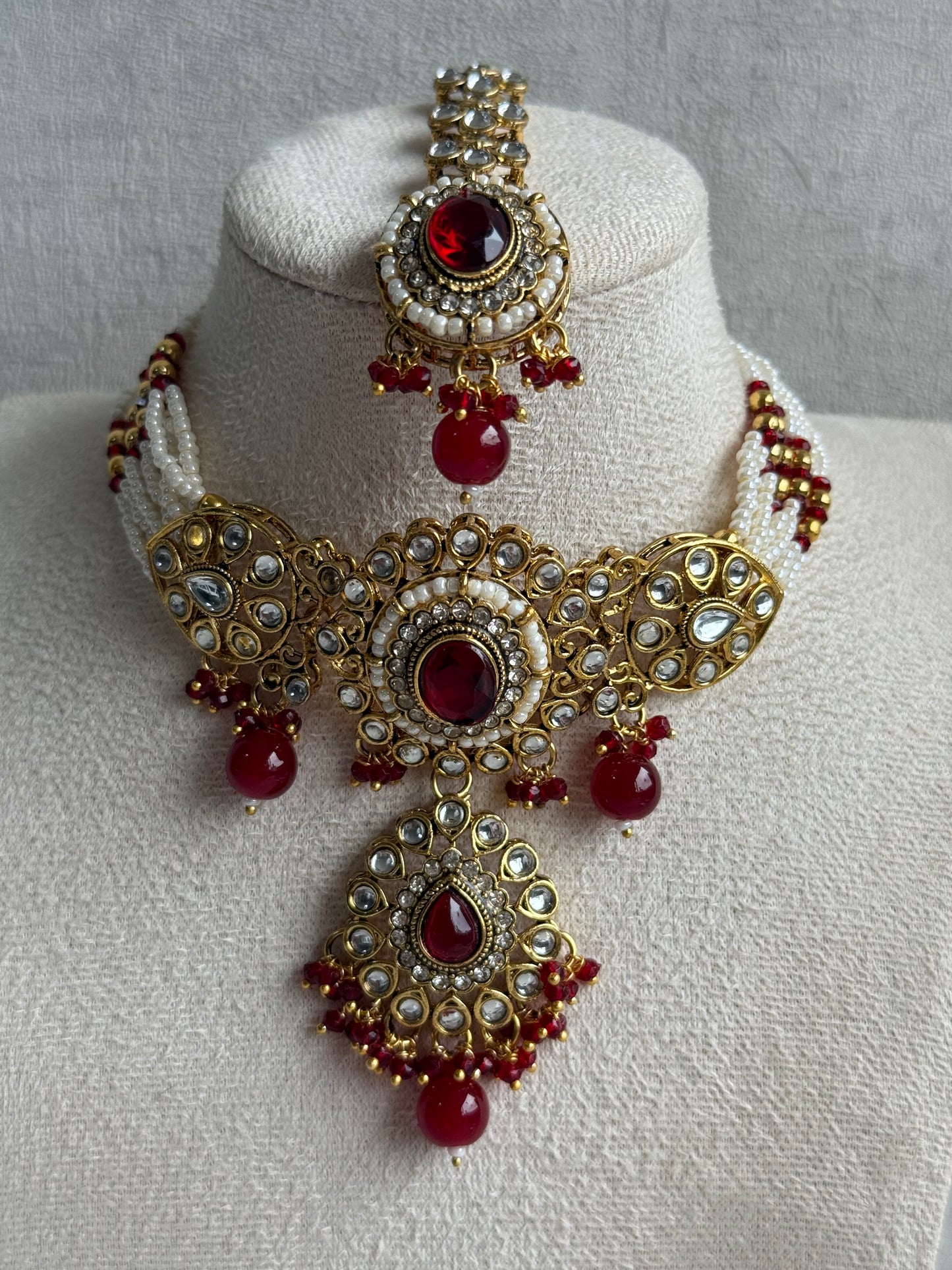 Ayura Designs Muskaan Set – Choker, Jhumkis & Tikka with Ruby Red Beads, Kundan Stones & Antique Gold Finish