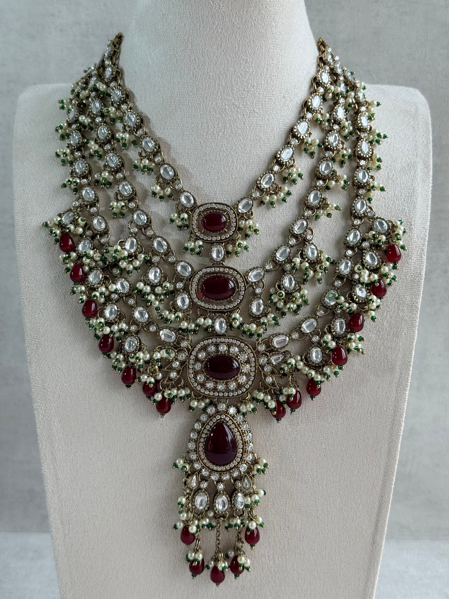 Ayura Designs Sahra Bridal Set with Earrings & Tikka – Ruby Red, Kundan Stones, Pearls & Emerald Green Accents in Antique Gold Finish