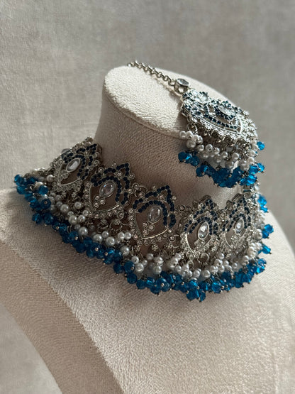 Ayura Designs Wania Set with Jhumkis, Tikka & Passa – Peacock Blue Beads, Mirror-Cut Stones & Antique Silver Finish