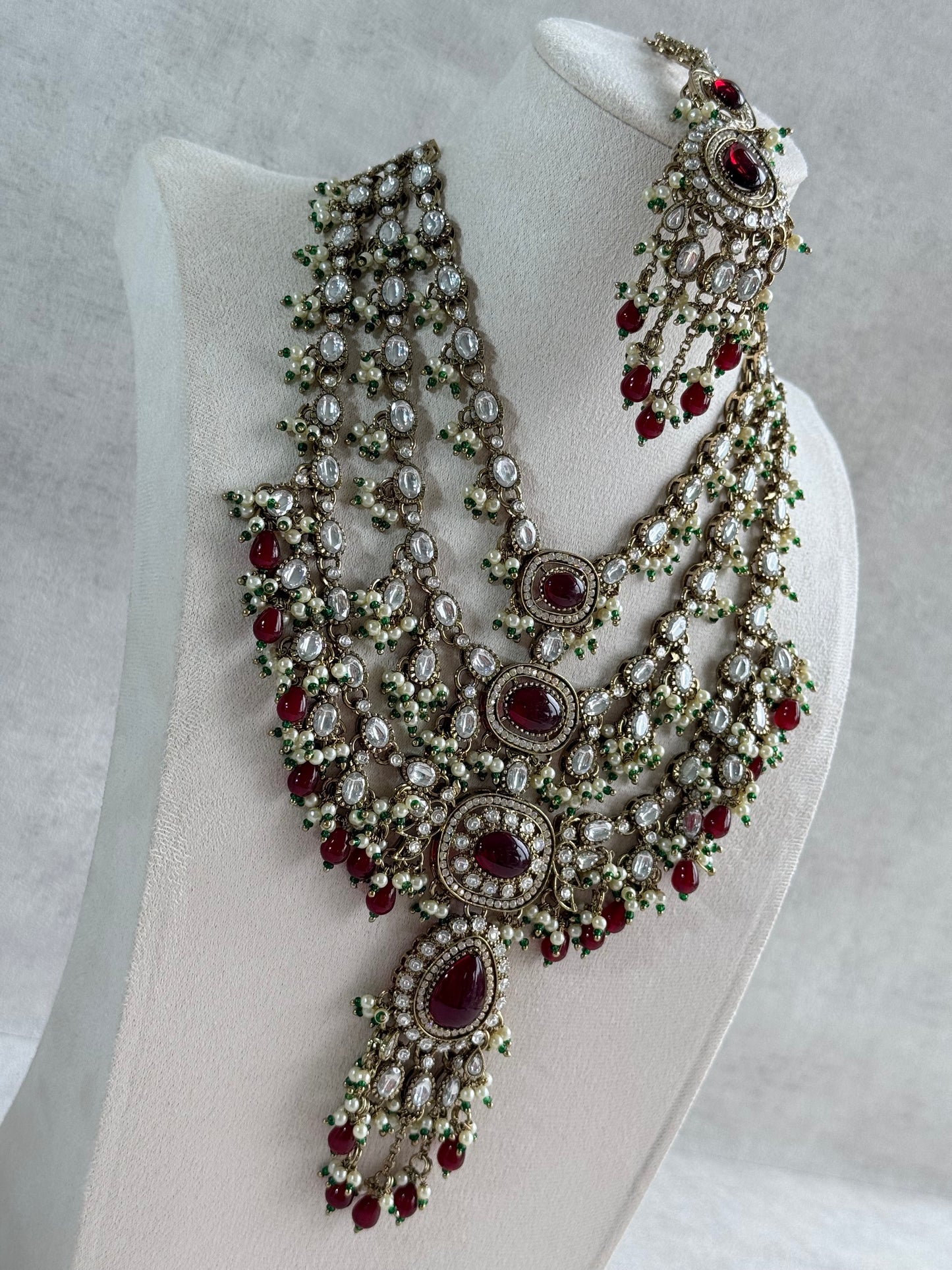 Ayura Designs Sahra Bridal Set with Earrings & Tikka – Ruby Red, Kundan Stones, Pearls & Emerald Green Accents in Antique Gold Finish