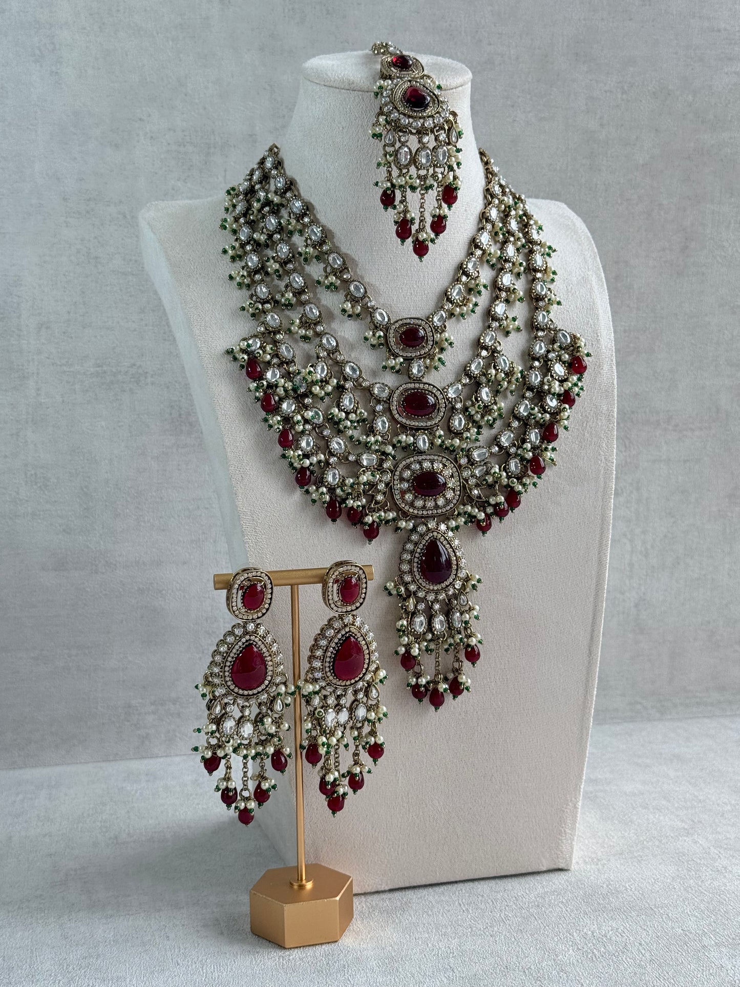 Ayura Designs Sahra Bridal Set with Earrings & Tikka – Ruby Red, Kundan Stones, Pearls & Emerald Green Accents in Antique Gold Finish