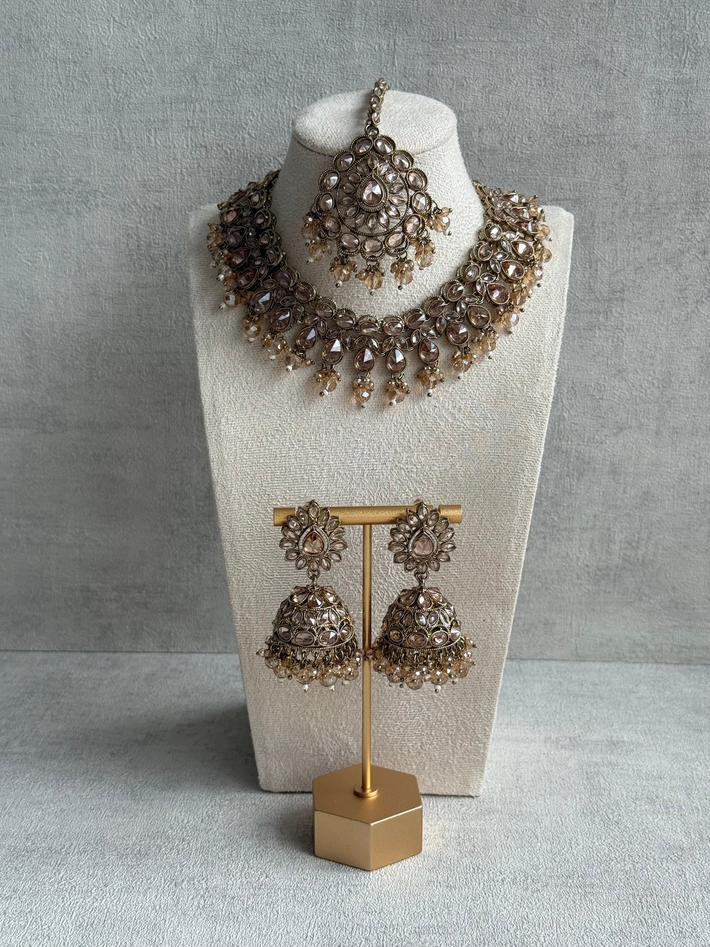 Ayura Designs Emaan Set with Jhumkis & Tikka – Champagne Stones, Antique Gold Finish & Crystal Detailing