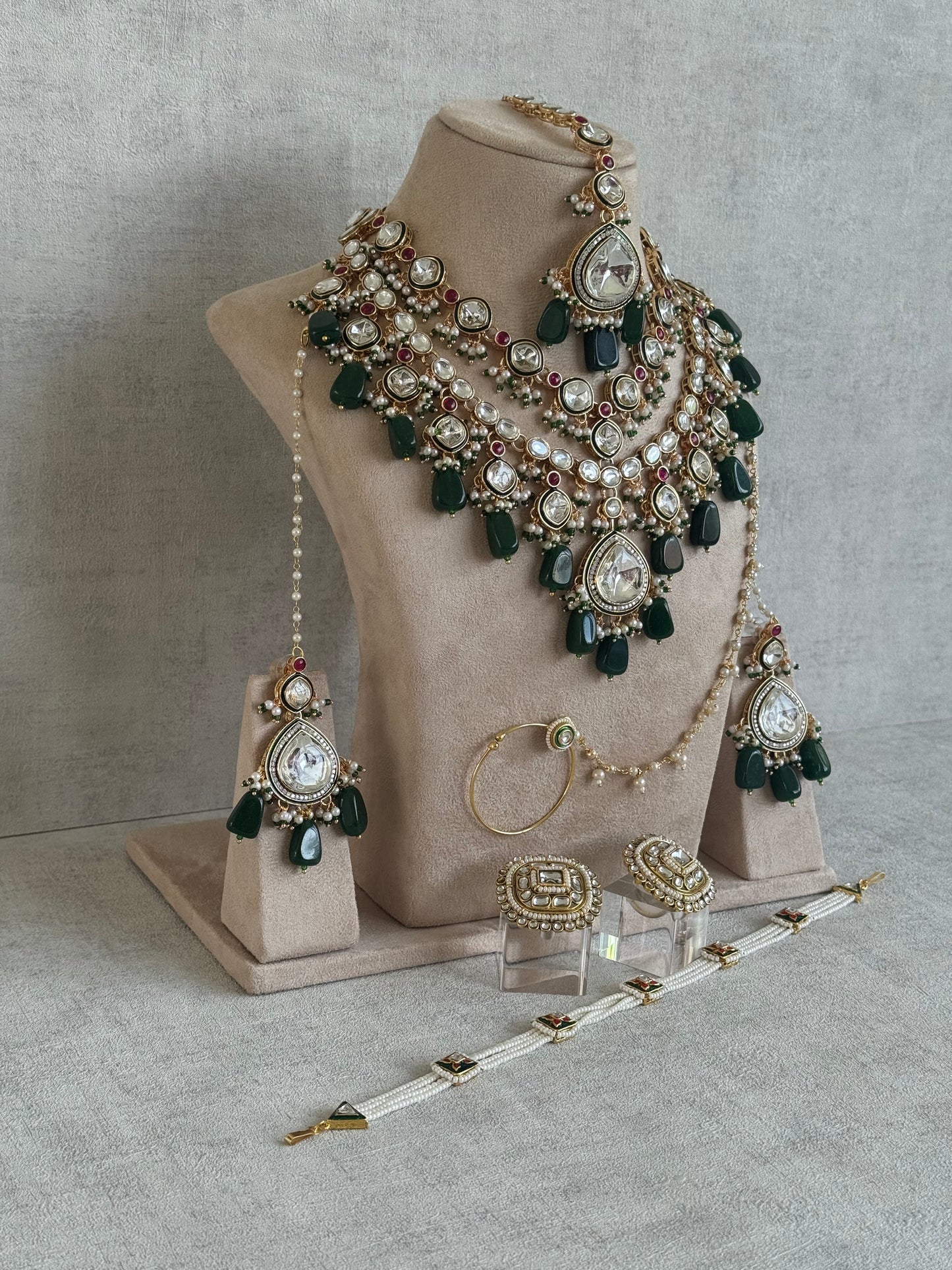 Ayura Designs Malika Bridal Set with Necklace, Jhumkis, Tikka, Nath, Ring & Sheeshphool – Jadau Kundan Craftsmanship with Mirror-Cut Polki, Emerald Green Drops, Ruby Accents & Antique Gold Finish