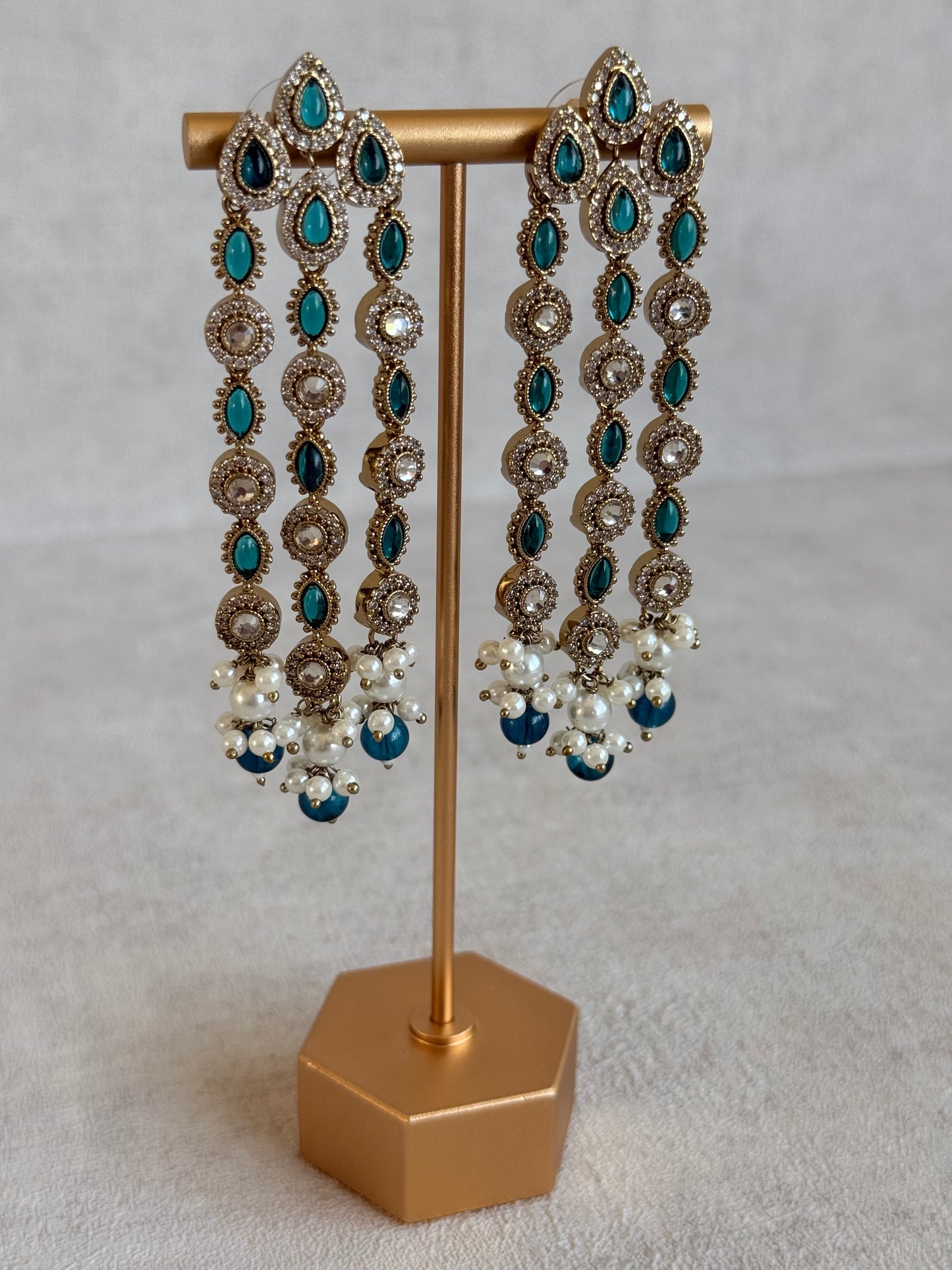 Ayura Designs Emilia Earrings – Gold Triple Strand Statement Earrings with Peacock Blue Stones & Pearl Drops