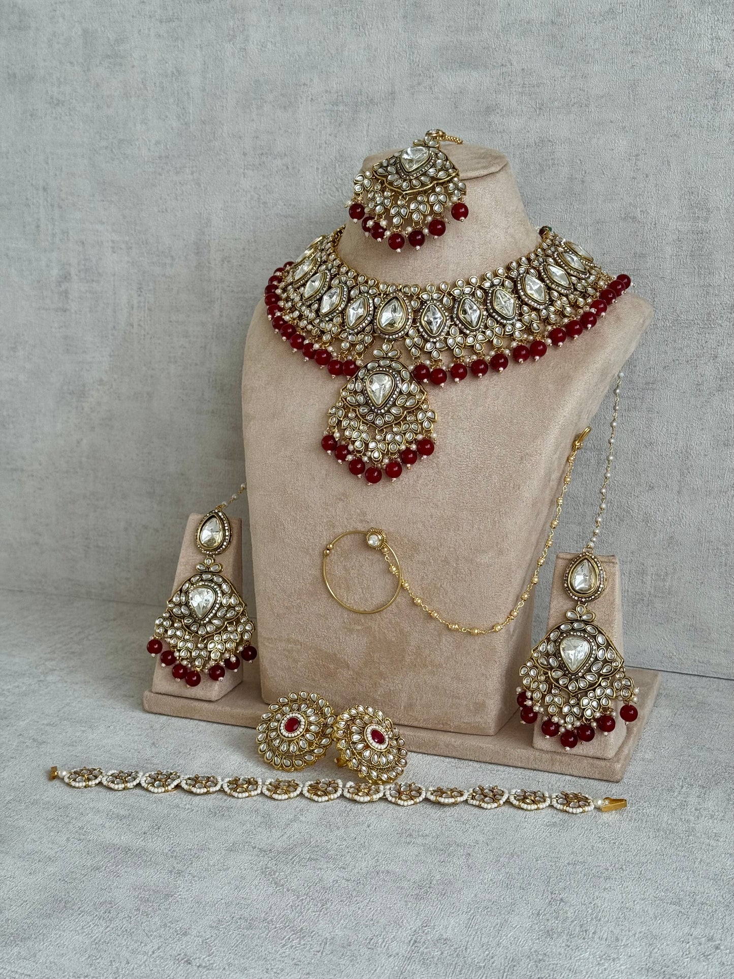 Ayura Designs Gulbahar Bridal Set with Necklace, Jhumkis, Tikka, Nath, Ring & Sheeshphool – Jadau Kundan Craftsmanship with Mirror-Cut Polki, Red Beads & Antique Gold Finish