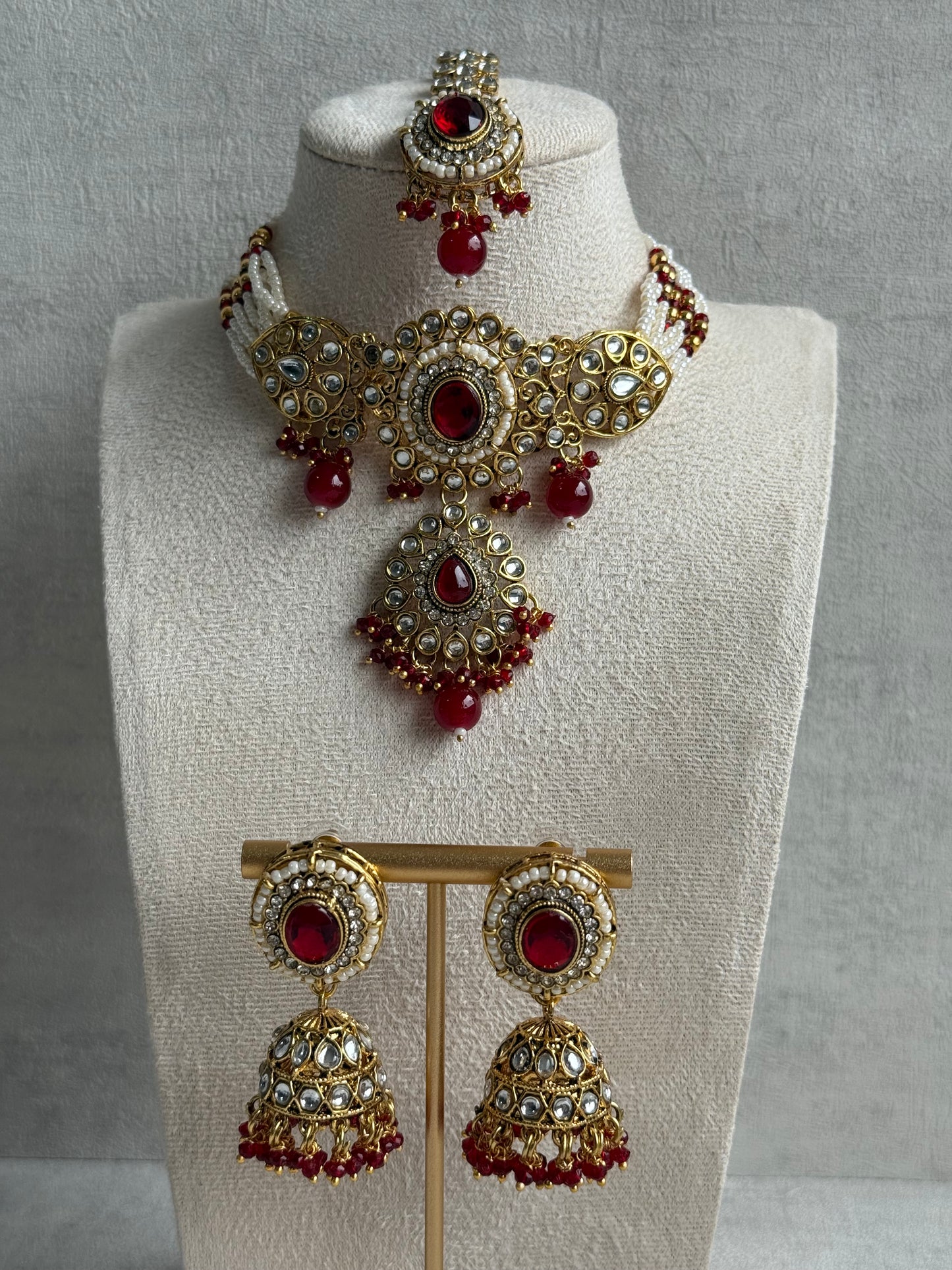 Ayura Designs Muskaan Set – Choker, Jhumkis & Tikka with Ruby Red Beads, Kundan Stones & Antique Gold Finish