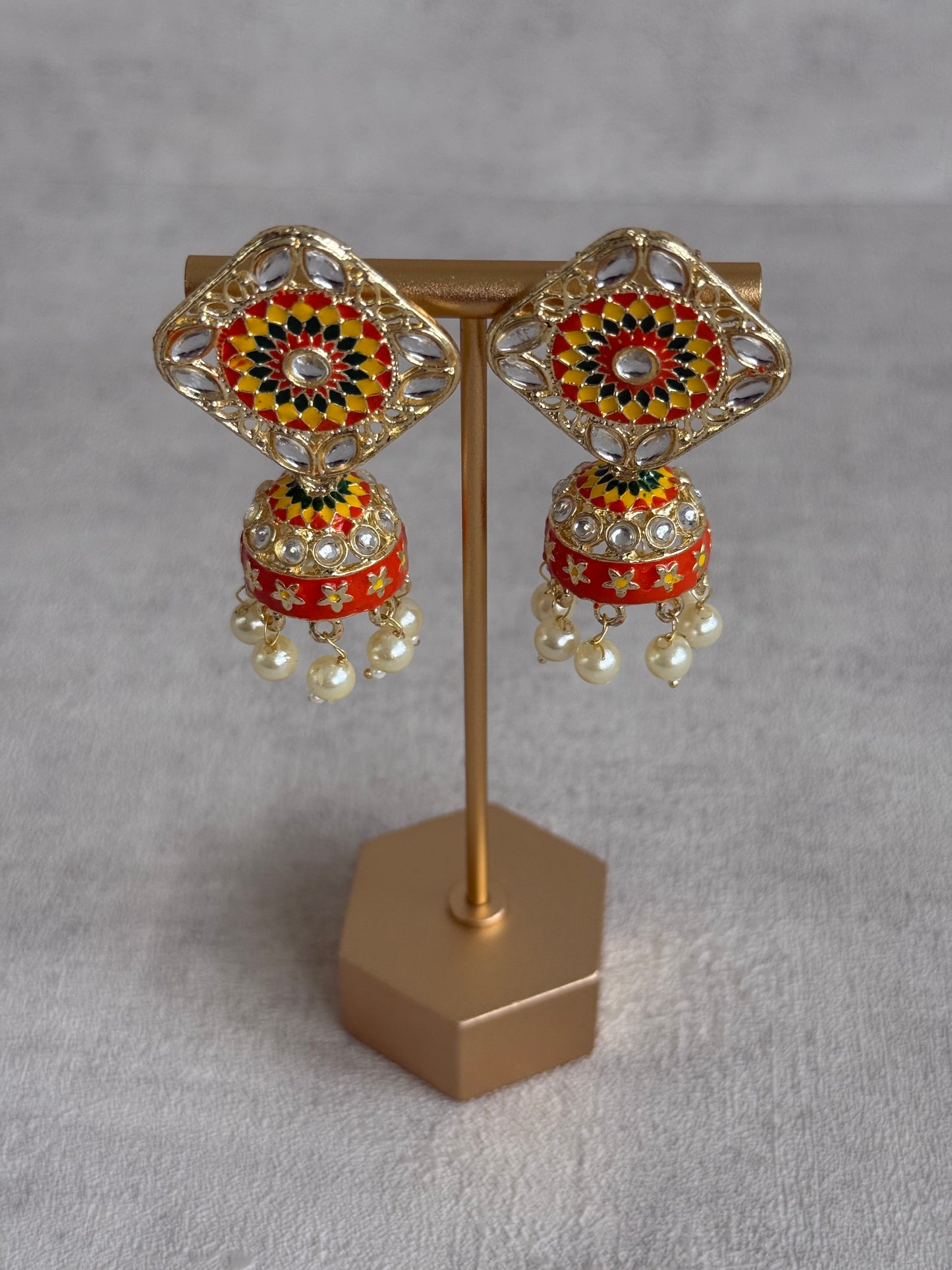 Ayura Designs Rangoli Jhumkis – Marigold Yellow, Ruby Red & Green Meenakari with Pearl Drops in Antique Gold Finish