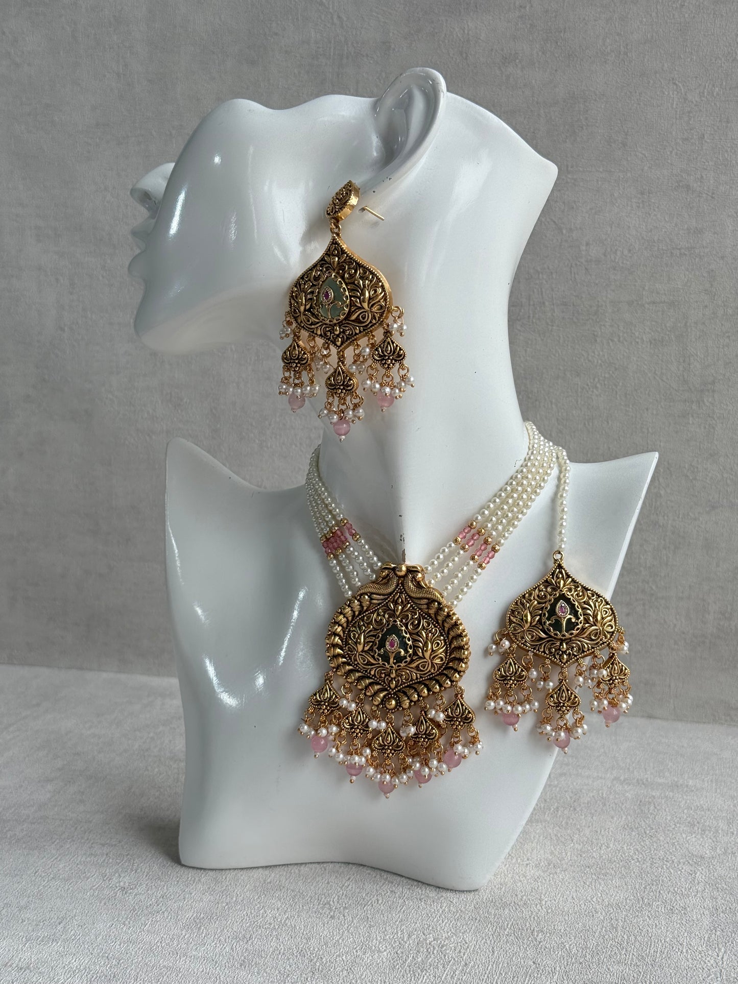 Ayura Designs Afia Necklace Set with Earrings & Tikka – Antique Gold, Blush Pink Pearls, Green Centre Stone & Peacock Motifs