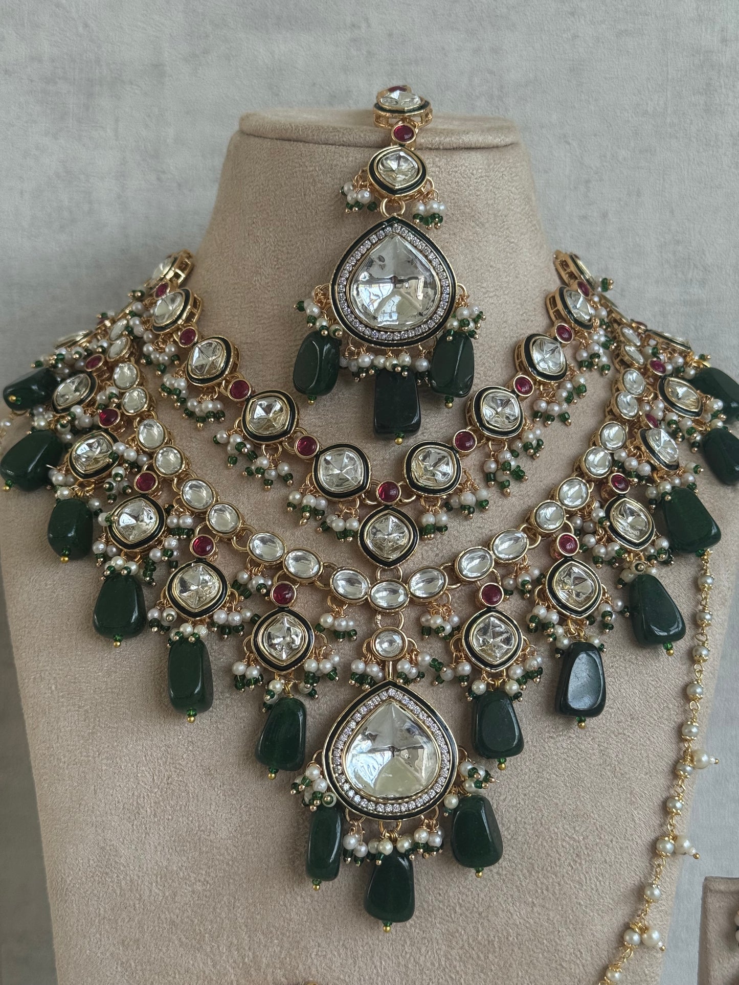 Ayura Designs Malika Bridal Set with Necklace, Jhumkis, Tikka, Nath, Ring & Sheeshphool – Jadau Kundan Craftsmanship with Mirror-Cut Polki, Emerald Green Drops, Ruby Accents & Antique Gold Finish
