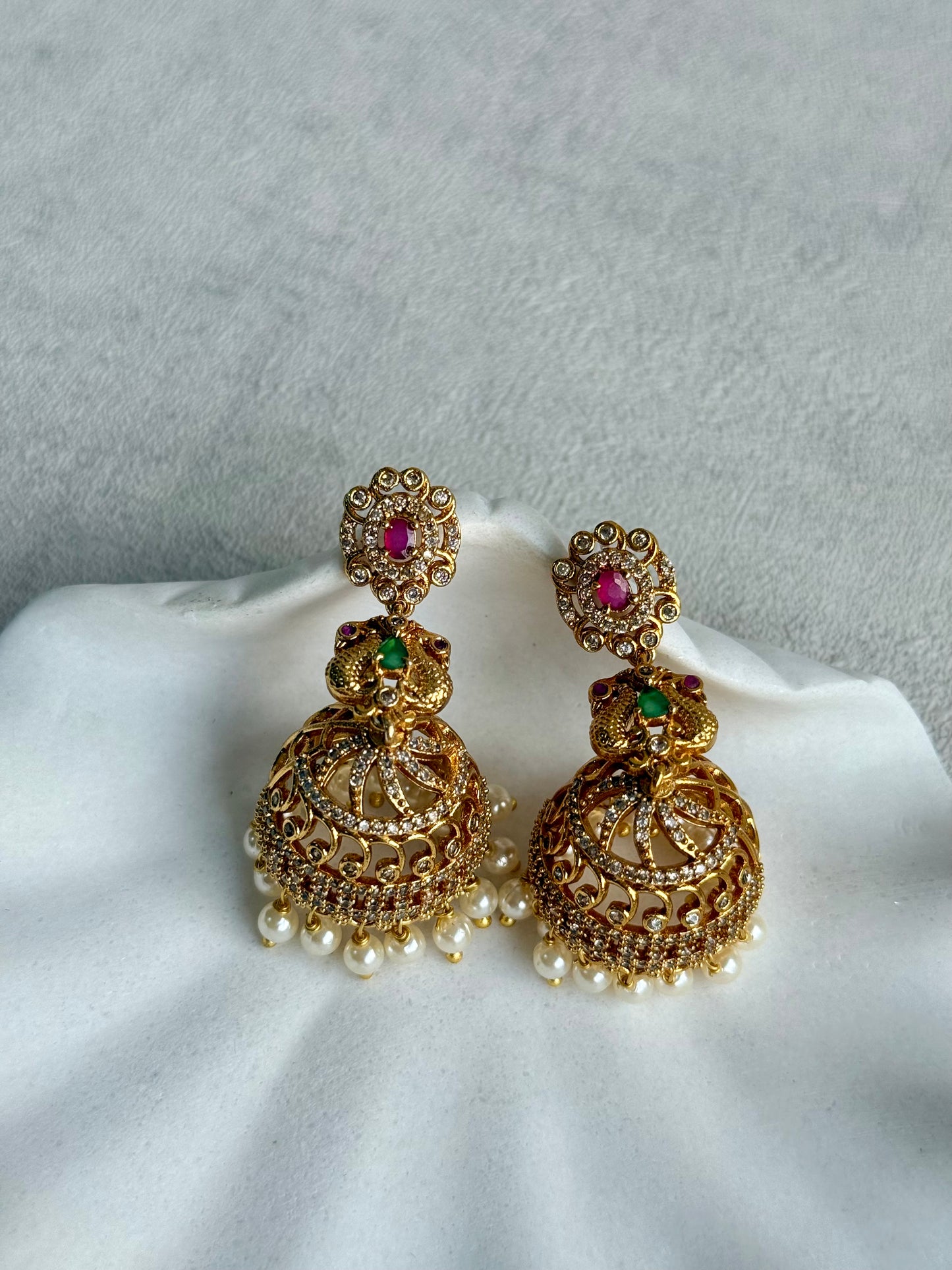 Ayura Designs Darya Jhumkis – Gold Peacock Motif Jhumkis with Ruby Pink, Emerald Green and Pearl Detailing