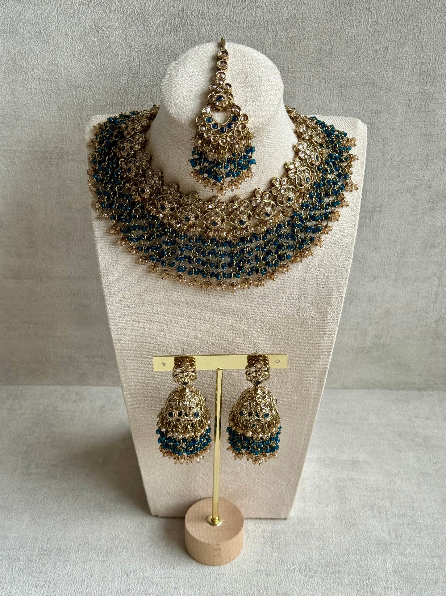Ayura Designs Mahreen Set – Necklace, Jhumkis & Tikka with Mirror-Cut Stones, Peacock Blue Beads & Gold Finish