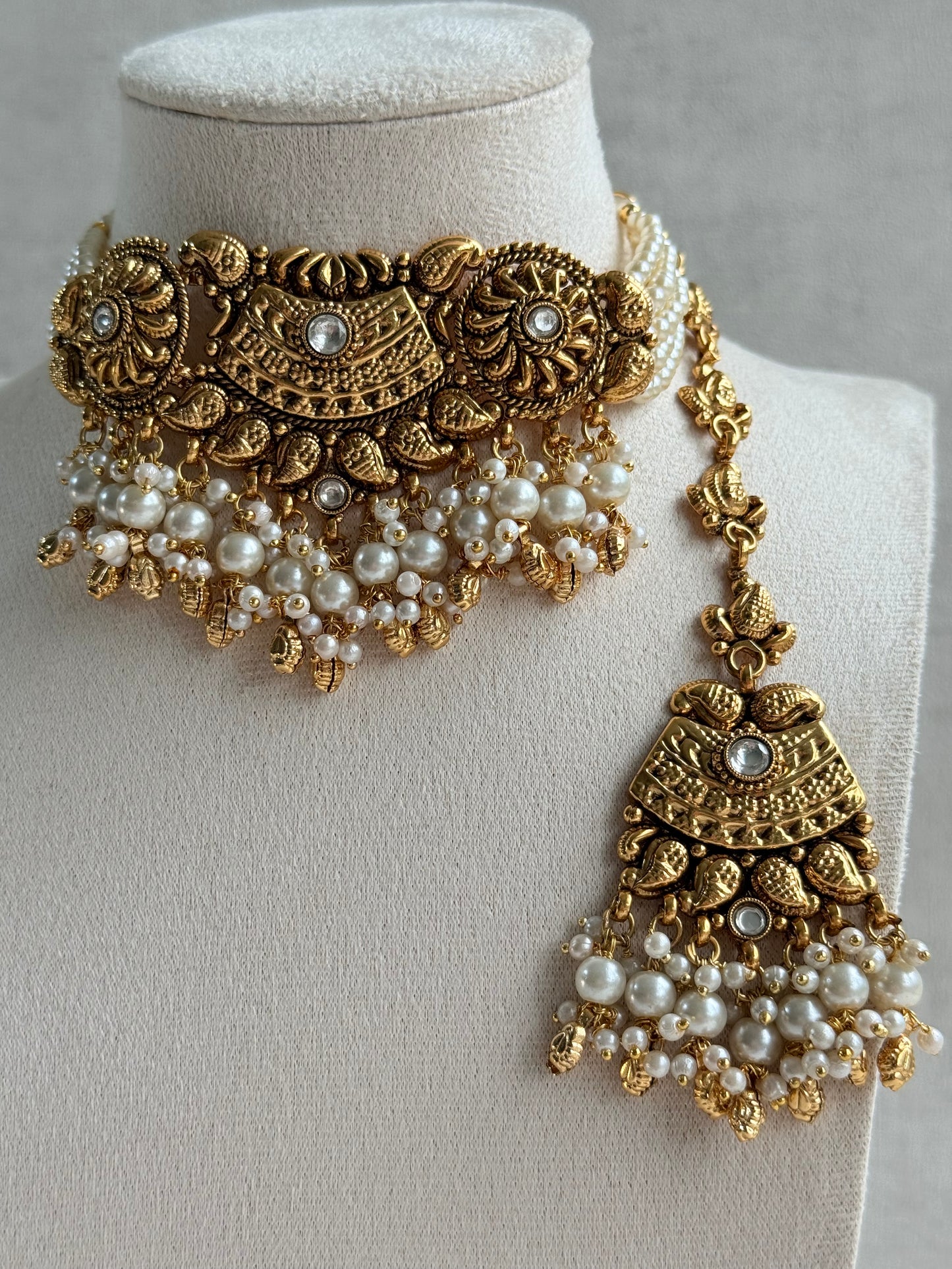 Ayura Designs Sairish Choker Set with Earrings & Tikka – Ivory Beads, Pearl Detailing, Ghungroos, Paisley Motifs & Antique Gold Finish