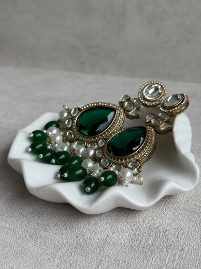 Ayura Designs Nageen Earrings – Antique Gold Jhumkis with Emerald Green Stones, Mirror-Cut Accents & Pearl Drops