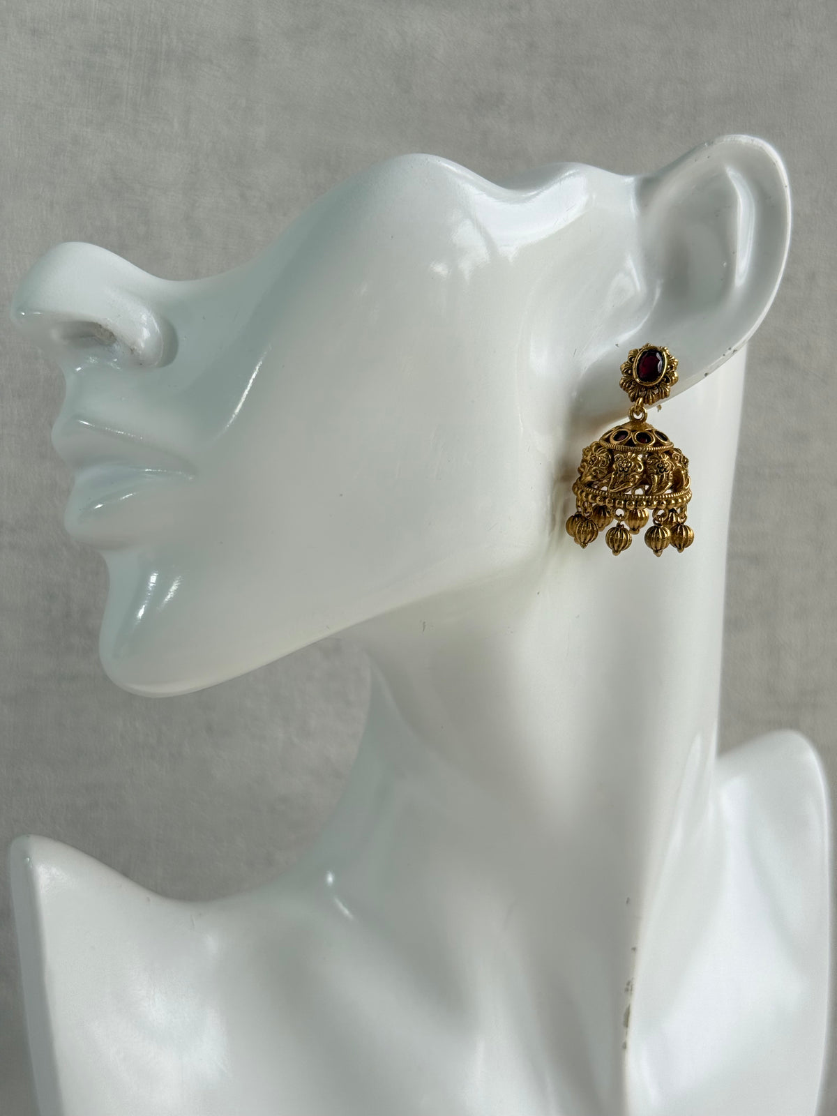 Ayura Designs Savya Jhumkis – Rani Pink Stones, Floral Motifs & Antique Gold Finish