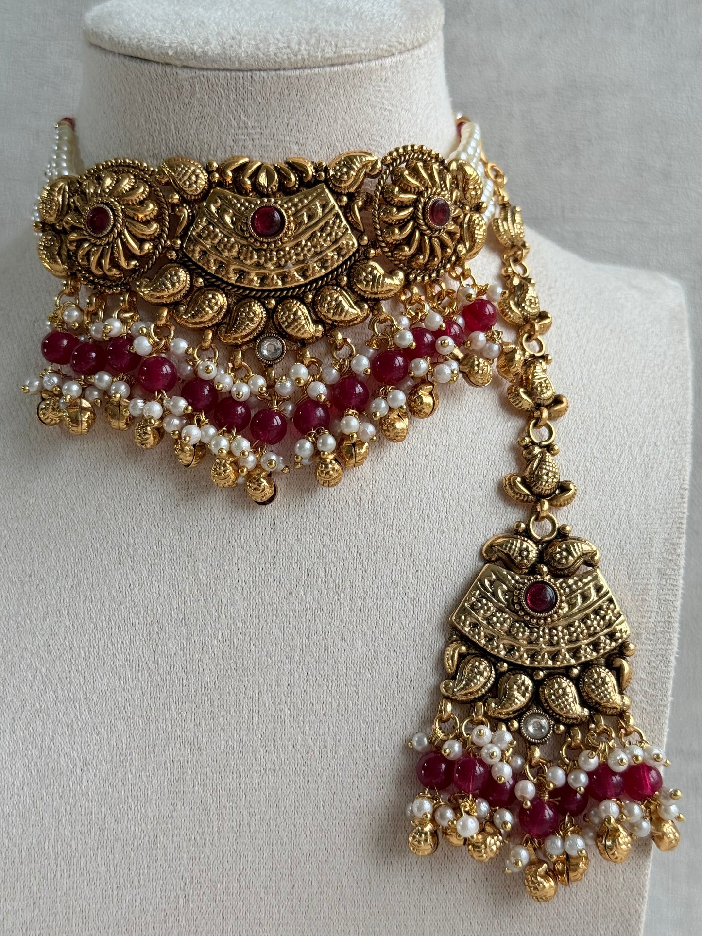 Ayura Designs Sairish Choker Set with Earrings & Tikka – Ruby Pink Beads, Pearl Detailing, Ghungroos, Paisley Motifs & Antique Gold Finish