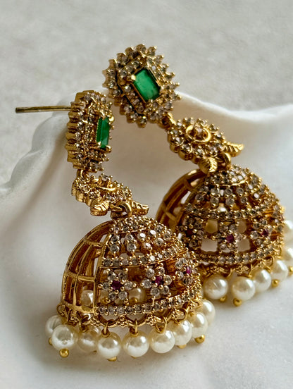 Ayura Designs Maya Jhumkis – Gold Jhumkis with Emerald Green Studs, Pink Stones, Crystal Detailing & Pearl Drops
