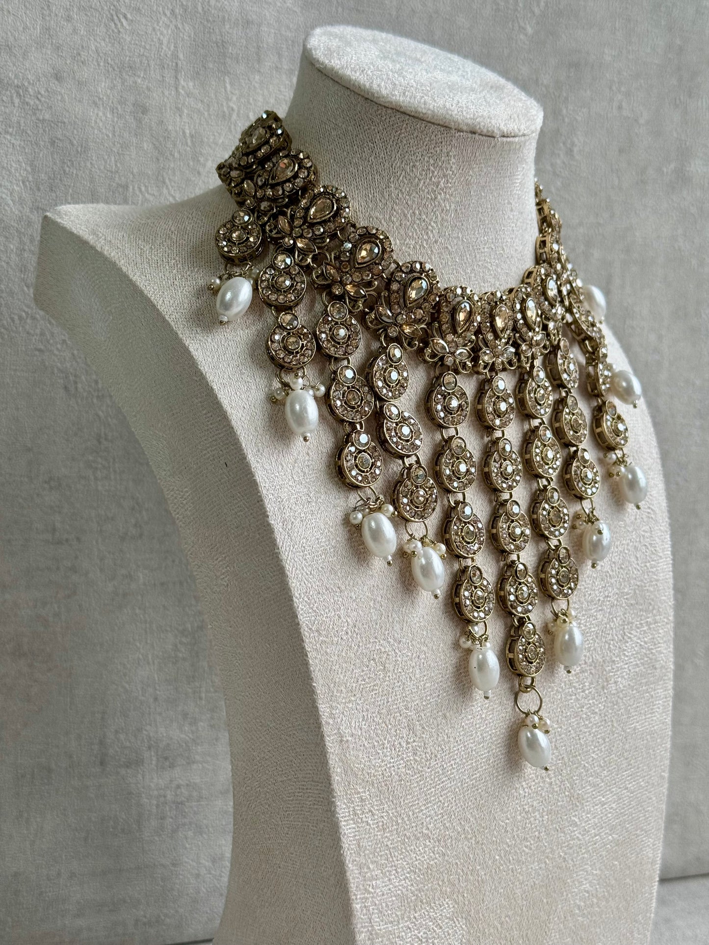 Ayura Designs Sameena Set – Opulent Champagne Gold Adorned with Luminous White Pearls Featuring a Statement Necklace, Tikka, and Chandelier Earrings