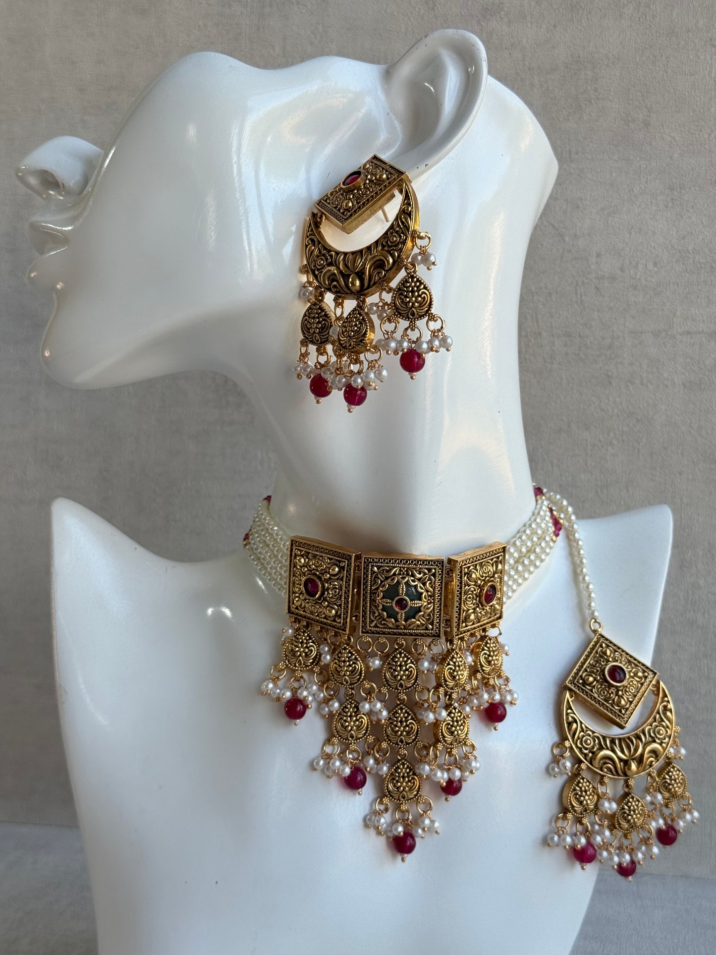 Ayura Designs Samera Choker Set with Earrings & Tikka – Rani Pink Beads, Pearl Detailing, Green Centre Stone, Floral Motifs & Antique Gold Finish