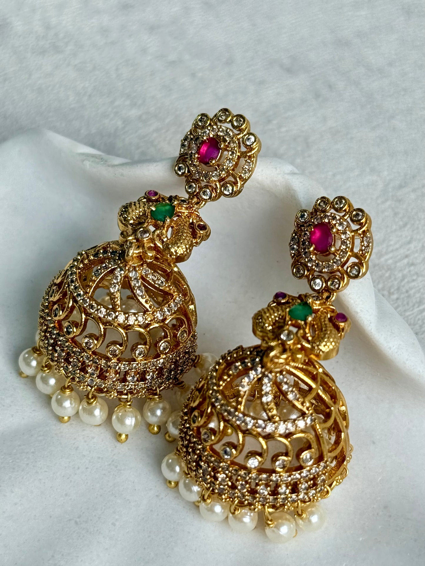 Ayura Designs Darya Jhumkis – Gold Peacock Motif Jhumkis with Ruby Pink, Emerald Green and Pearl Detailing