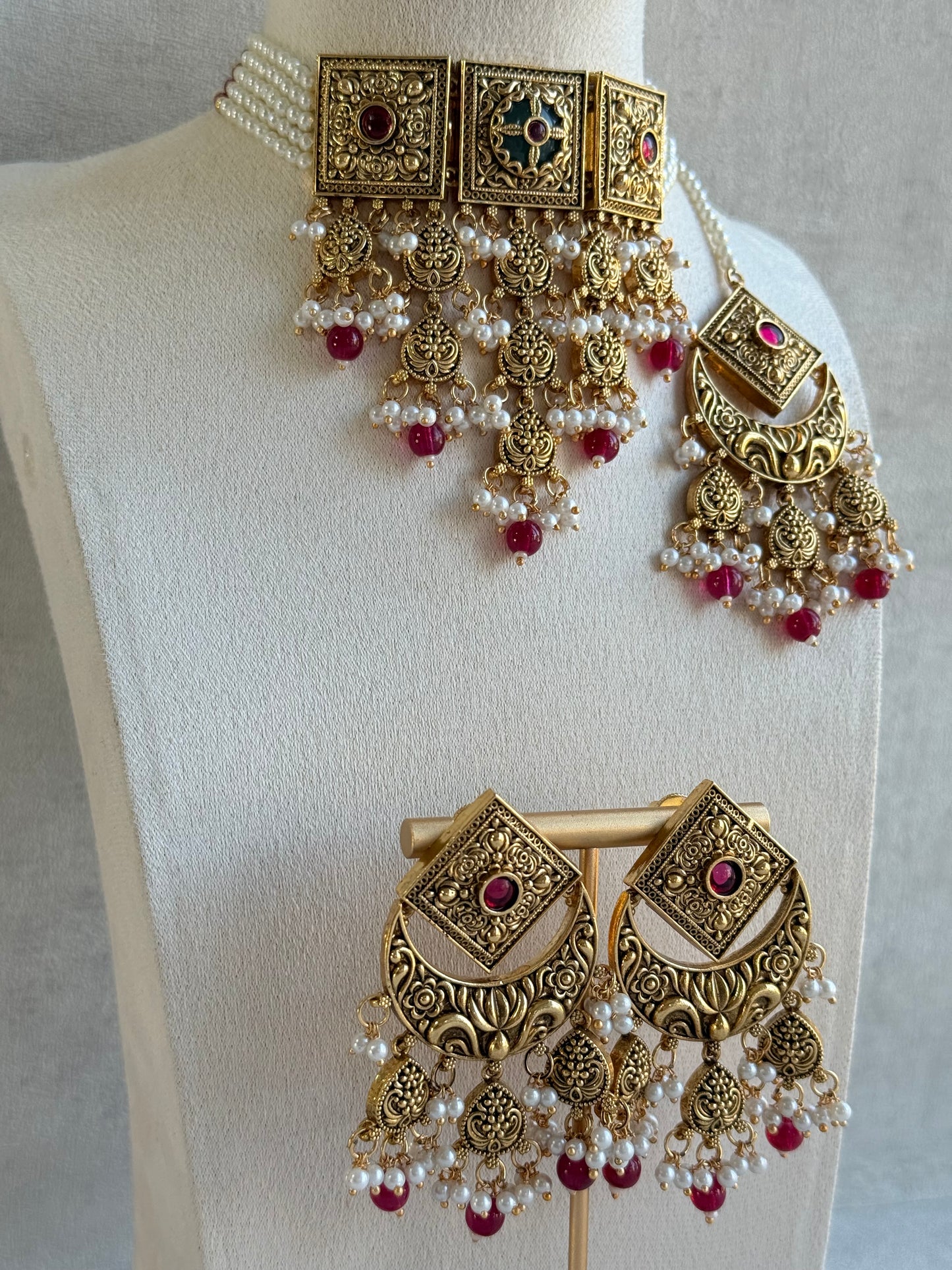 Ayura Designs Samera Choker Set with Earrings & Tikka – Rani Pink Beads, Pearl Detailing, Green Centre Stone, Floral Motifs & Antique Gold Finish