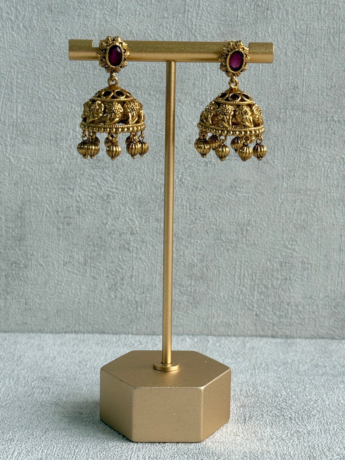 Ayura Designs Savya Jhumkis – Rani Pink Stones, Floral Motifs & Antique Gold Finish