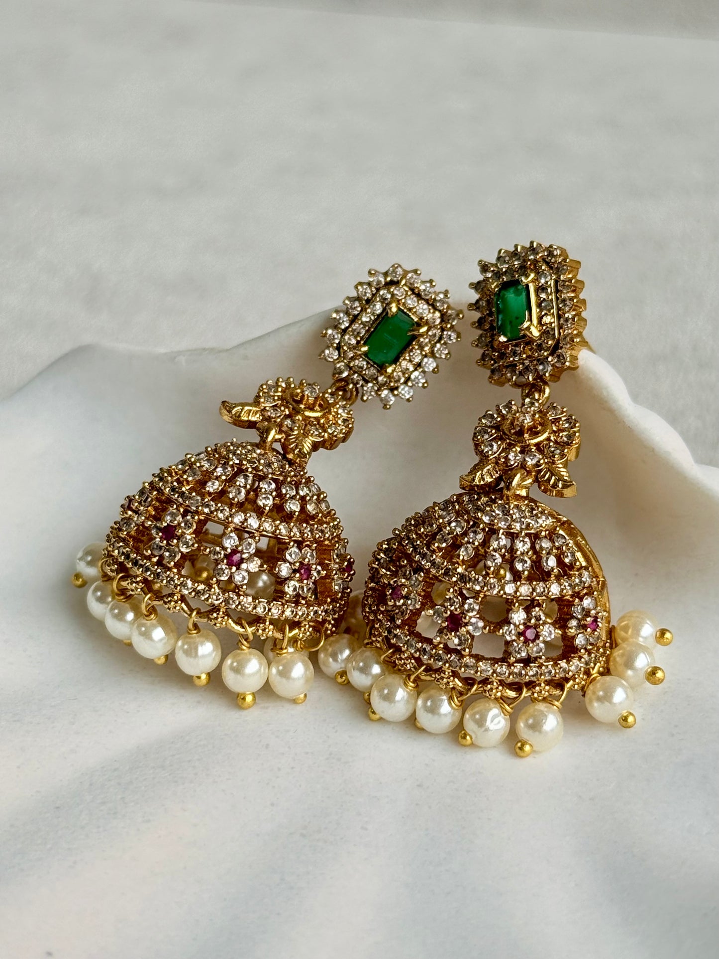 Ayura Designs Maya Jhumkis – Gold Jhumkis with Emerald Green Studs, Pink Stones, Crystal Detailing & Pearl Drops