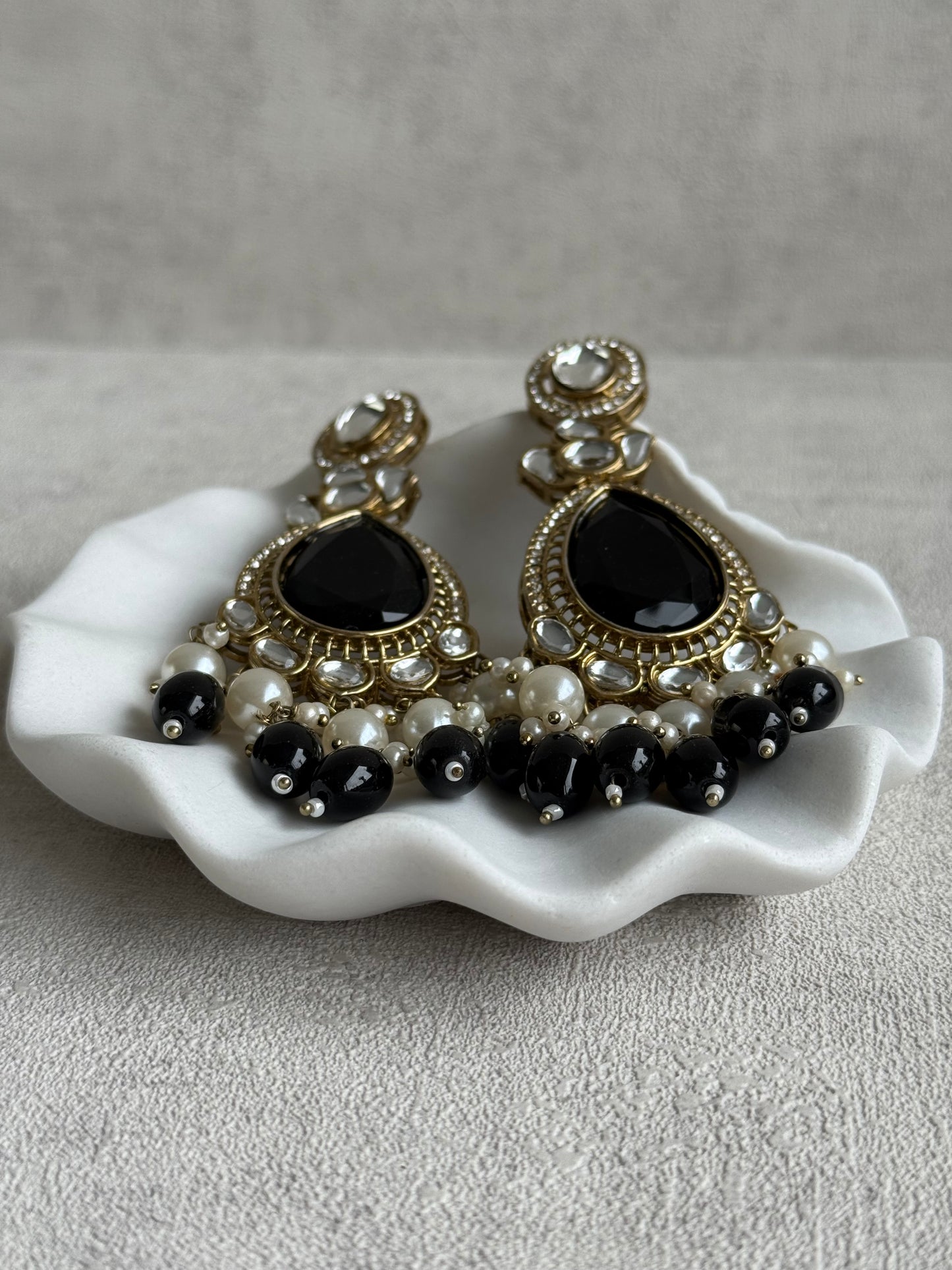 Ayura Designs Nageen Earrings – Antique Gold Jhumkis with Black Stones, Mirror-Cut Accents & Pearl Drops