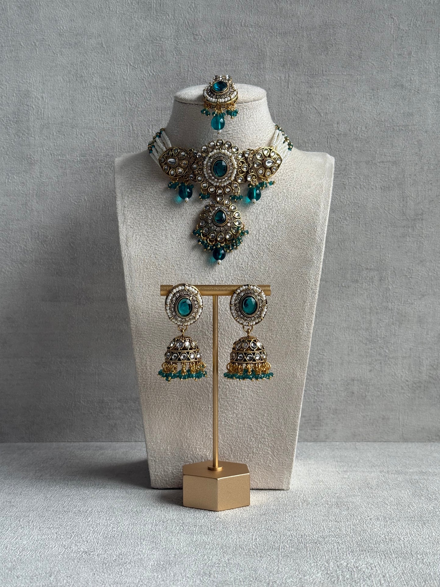 Ayura Designs Muskaan Set – Choker, Jhumkis & Tikka with Peacock Blue Beads, Kundan Stones & Antique Gold Finish