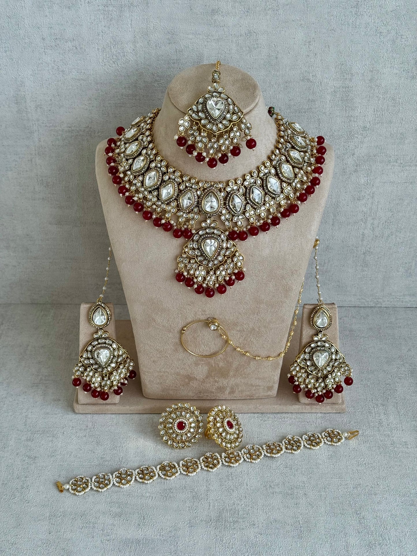 Ayura Designs Gulbahar Bridal Set with Necklace, Jhumkis, Tikka, Nath, Ring & Sheeshphool – Jadau Kundan Craftsmanship with Mirror-Cut Polki, Red Beads & Antique Gold Finish