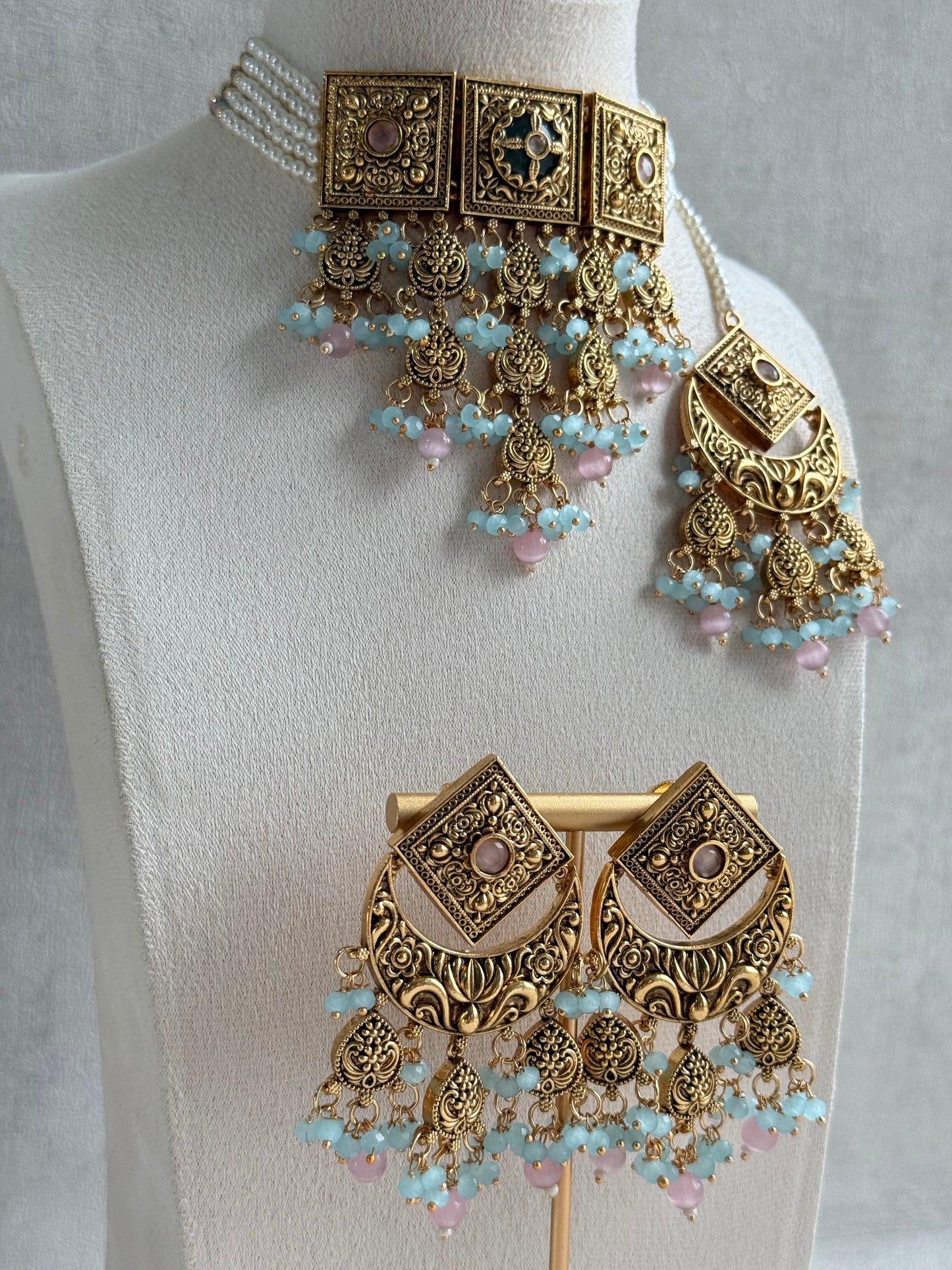 Ayura Designs Samera Choker Set with Earrings & Tikka – Aqua Blue & Blush Pink Beads, Green Centre Stone, Floral Motifs & Antique Gold Finish