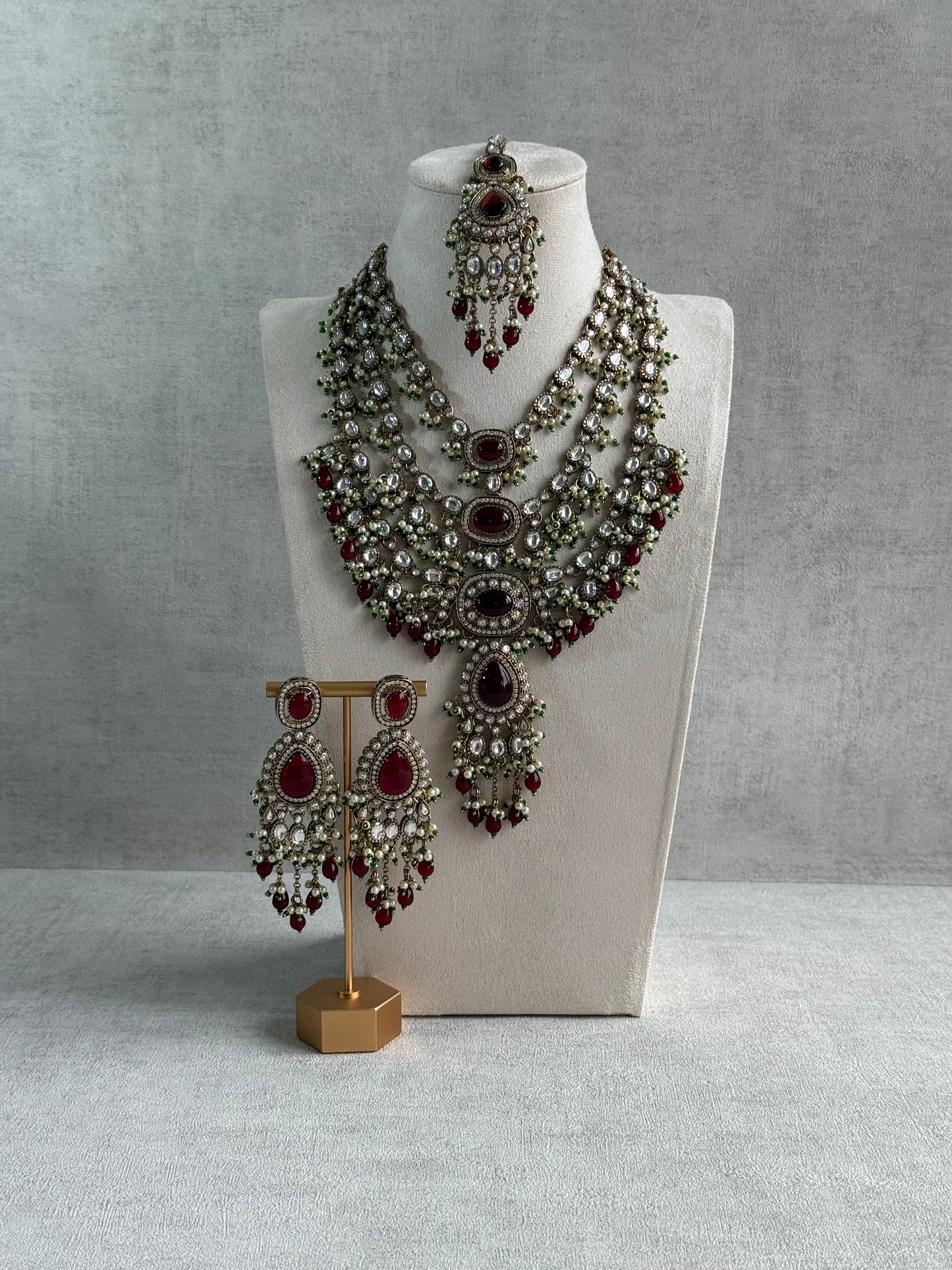 Ayura Designs Sahra Bridal Set with Earrings & Tikka – Ruby Red, Kundan Stones, Pearls & Emerald Green Accents in Antique Gold Finish