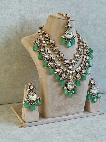 Ayura Designs Malika Bridal Set with Necklace, Jhumkis, Tikka, Nath, Ring & Sheeshphool – Jadau Kundan Craftsmanship with Mirror-Cut Polki, Jade-Toned Drops, Ruby Accents & Antique Gold Finish