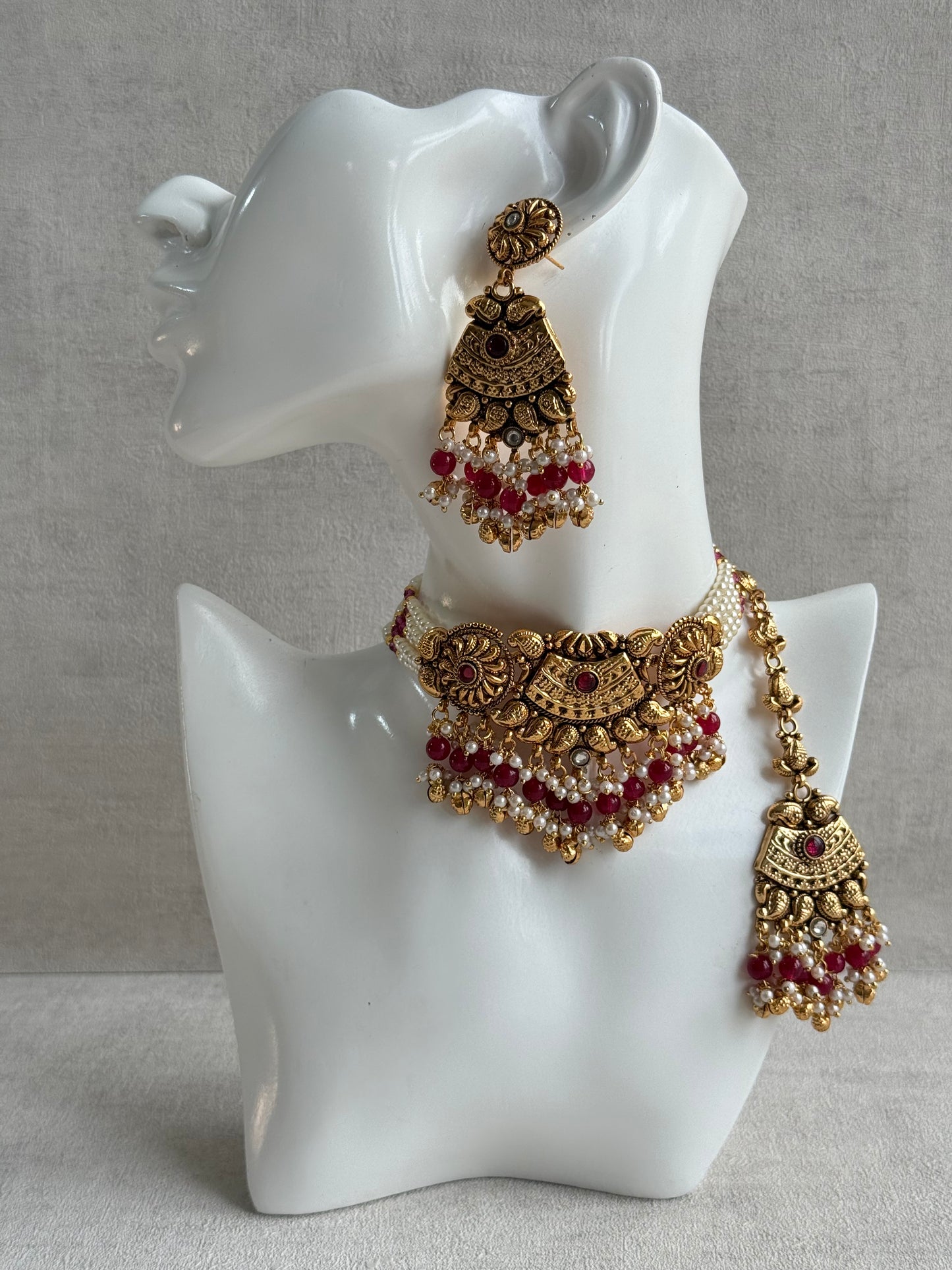 Ayura Designs Sairish Choker Set with Earrings & Tikka – Ruby Pink Beads, Pearl Detailing, Ghungroos, Paisley Motifs & Antique Gold Finish