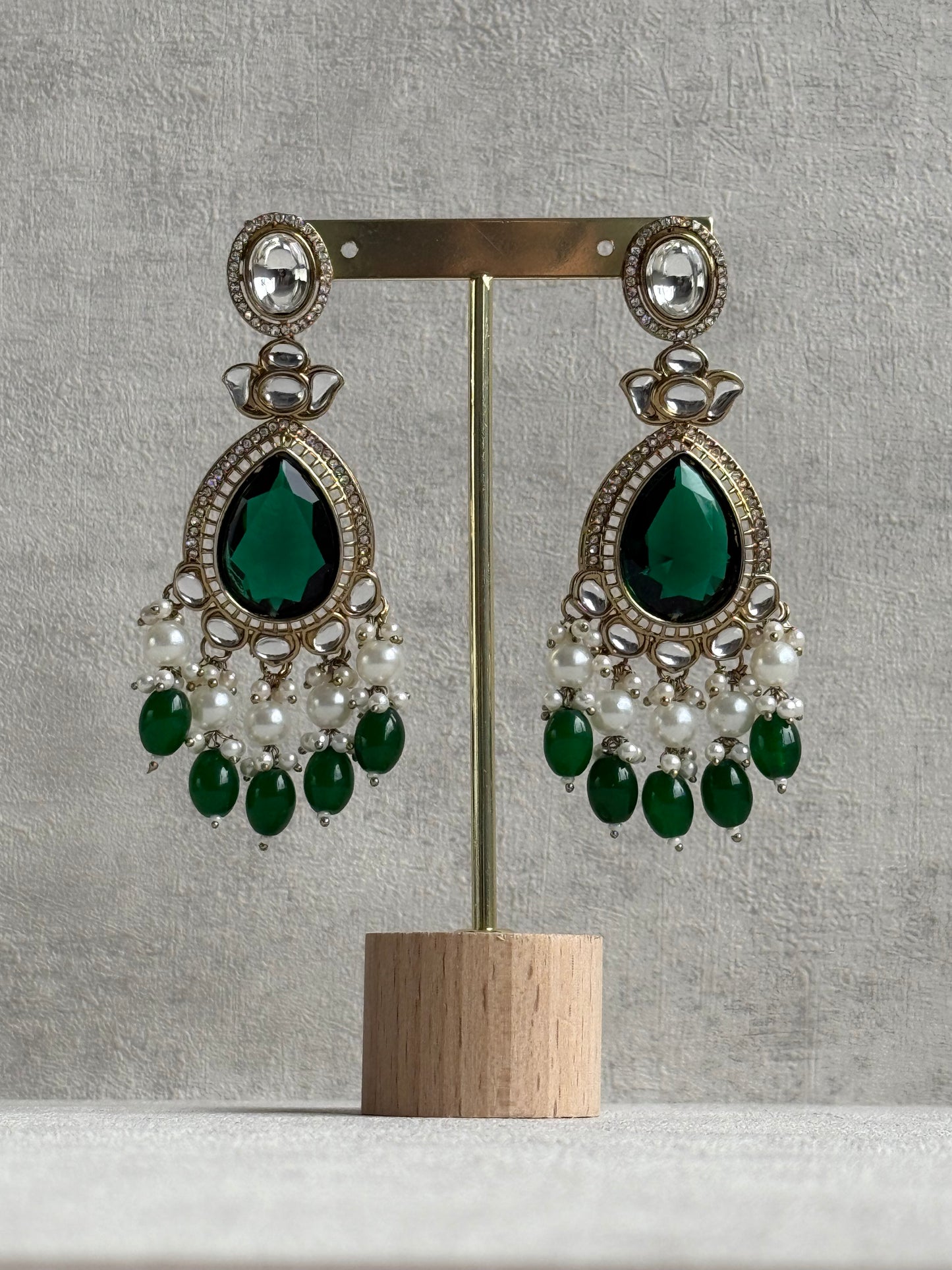 Ayura Designs Nageen Earrings – Antique Gold Jhumkis with Emerald Green Stones, Mirror-Cut Accents & Pearl Drops