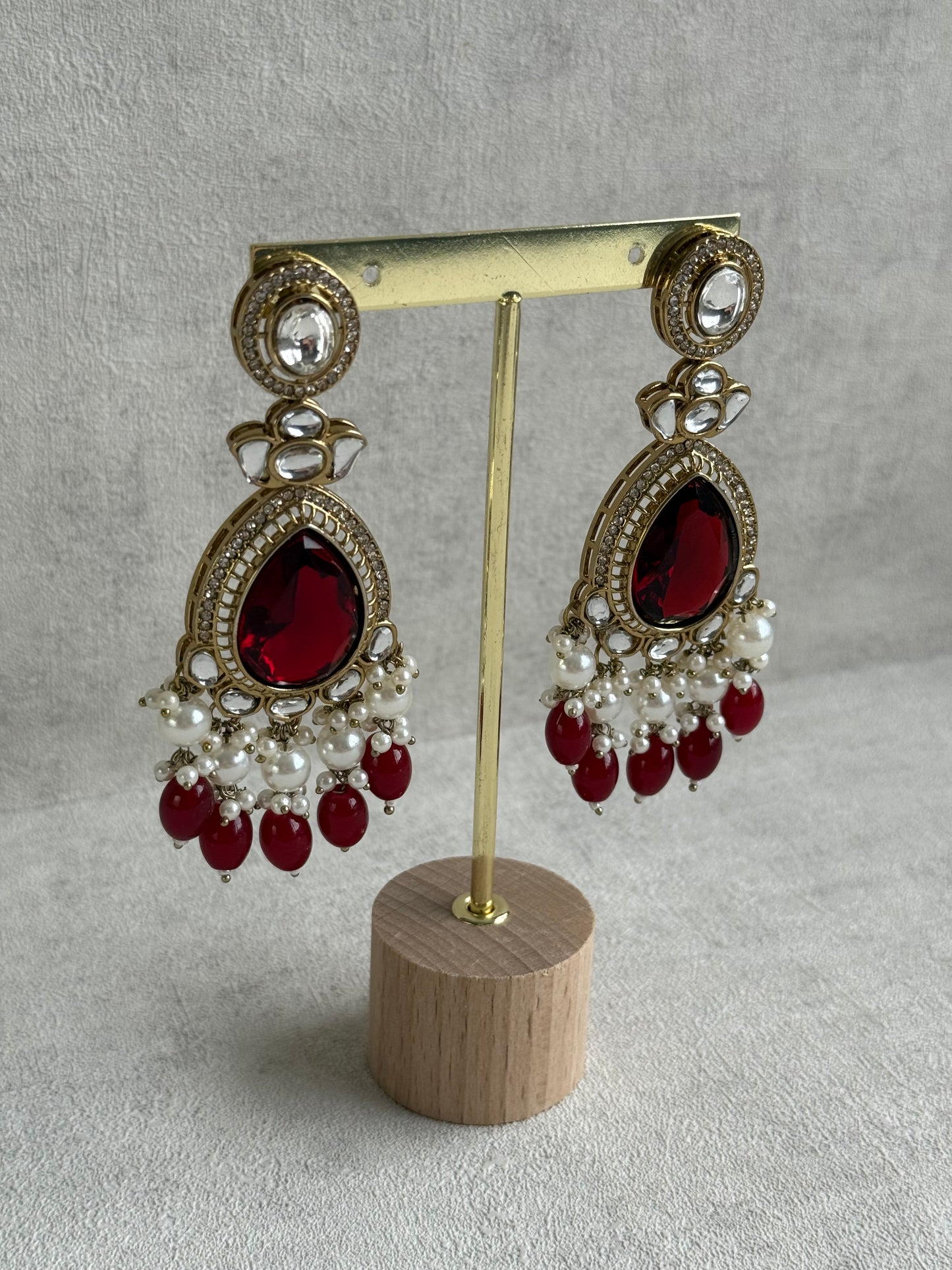 Ayura Designs Nageen Earrings – Antique Gold Jhumkis with Ruby Red Stones, Mirror-Cut Accents & Pearl Drops