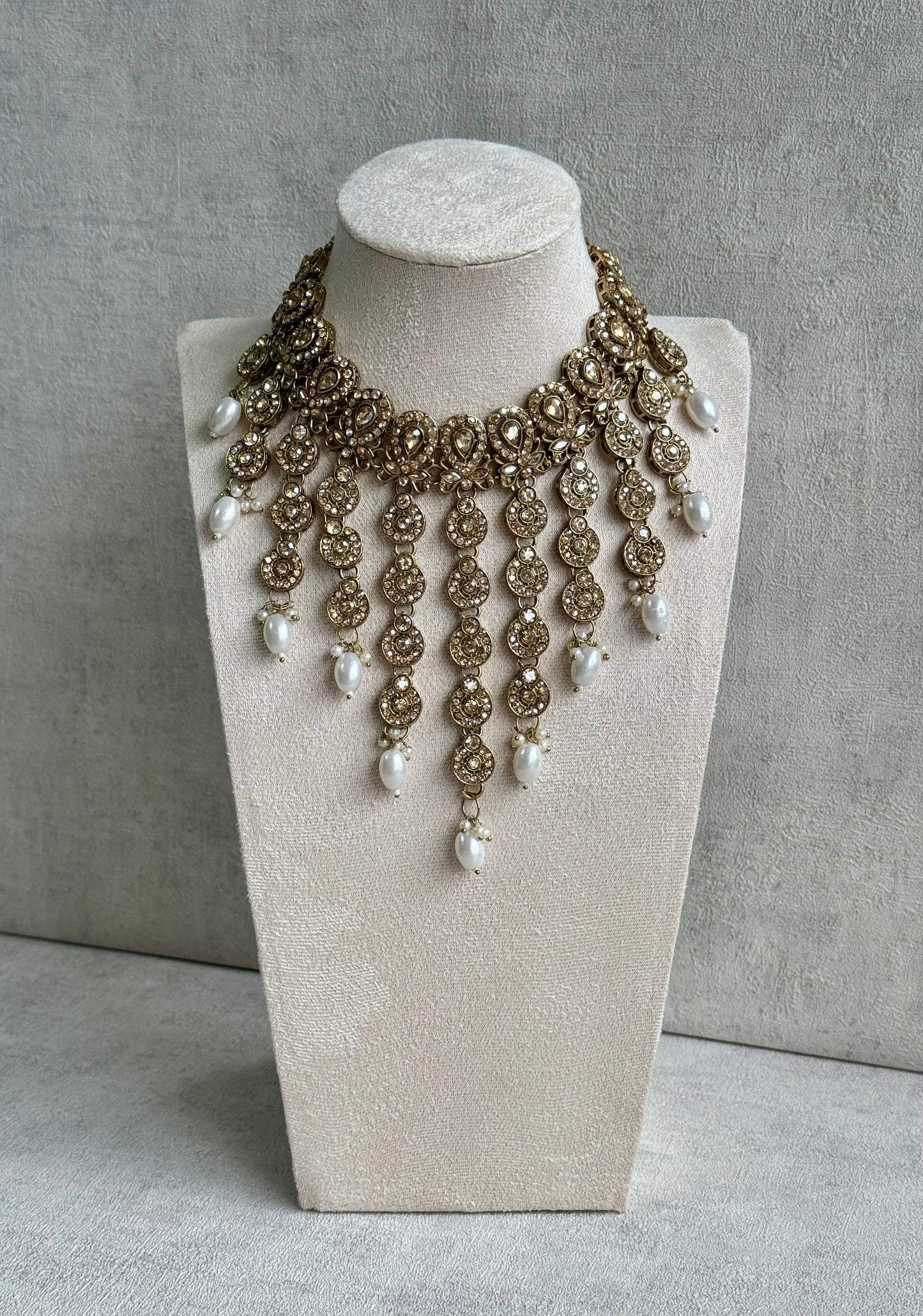 Ayura Designs Sameena Set – Opulent Champagne Gold Adorned with Luminous White Pearls Featuring a Statement Necklace, Tikka, and Chandelier Earrings