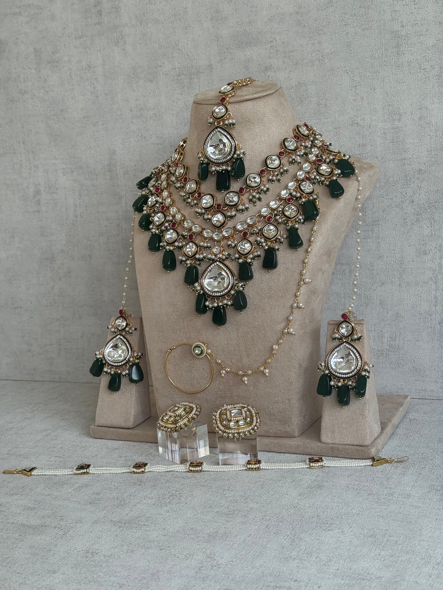 Ayura Designs Malika Bridal Set with Necklace, Jhumkis, Tikka, Nath, Ring & Sheeshphool – Jadau Kundan Craftsmanship with Mirror-Cut Polki, Emerald Green Drops, Ruby Accents & Antique Gold Finish